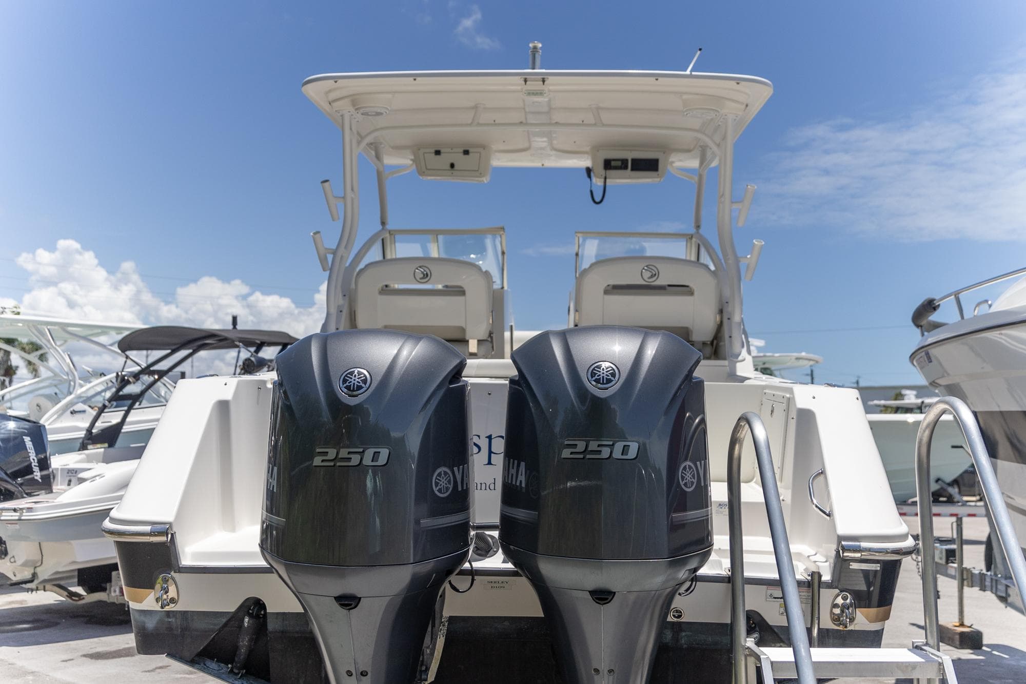 Edgewater 280 CX 2015 boat with twin Yamaha 250 engines, docked under clear blue sky.