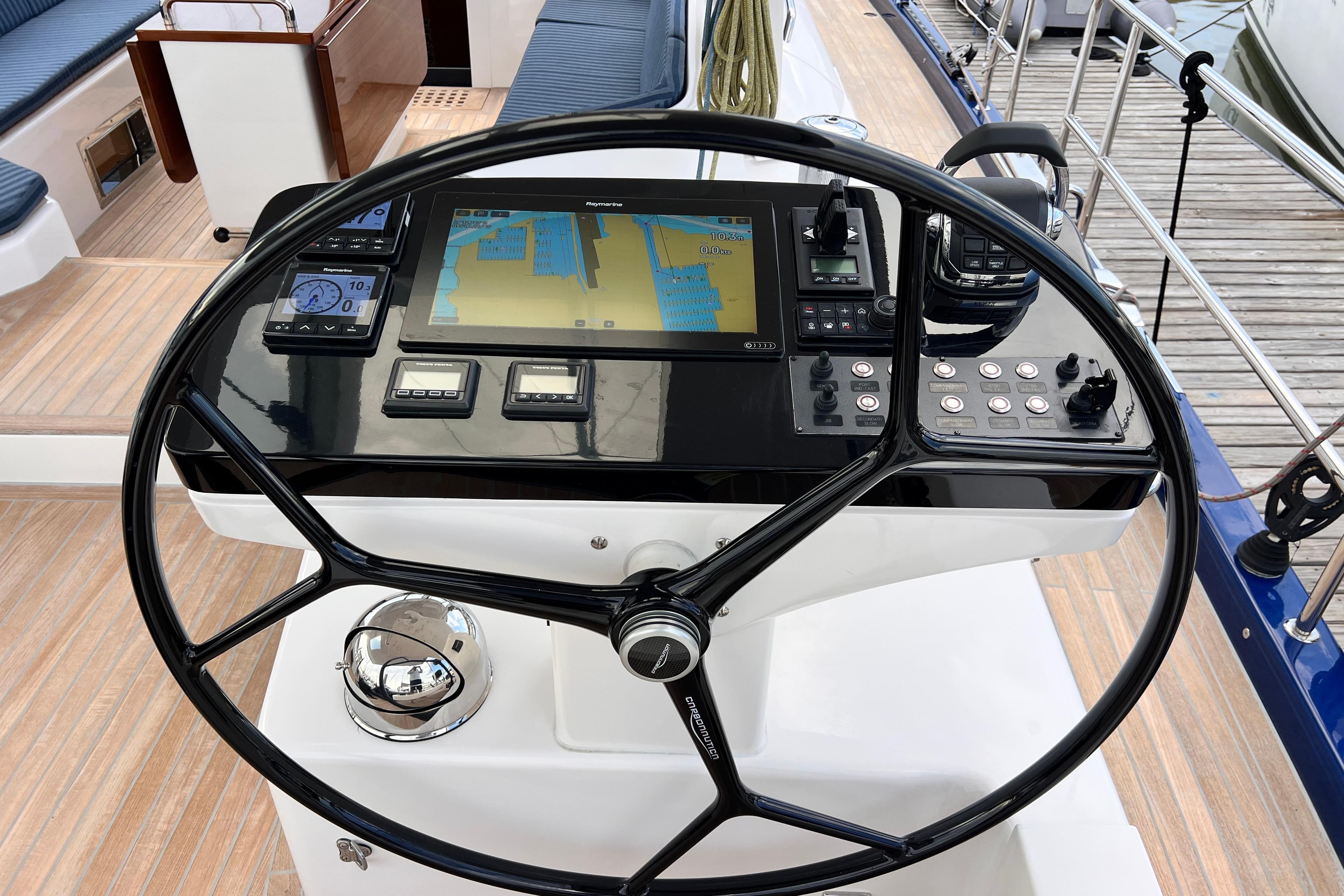 Helm of 2024 Hylas H57 yacht with navigation controls and display.