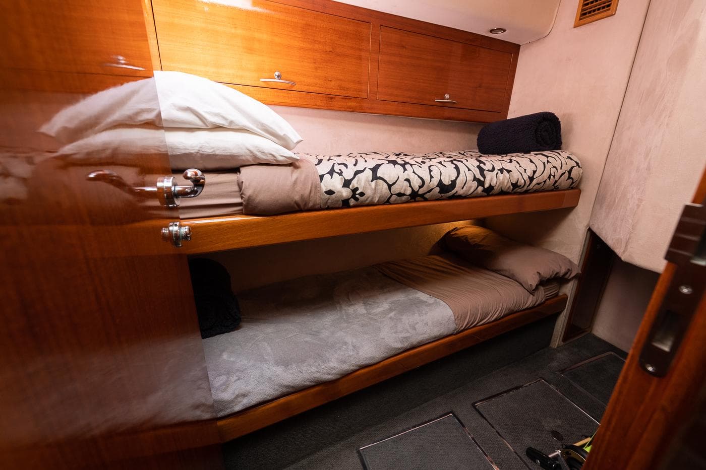2009 Maritimo 500 Offshore cabin with wooden bunk beds and storage cabinets.