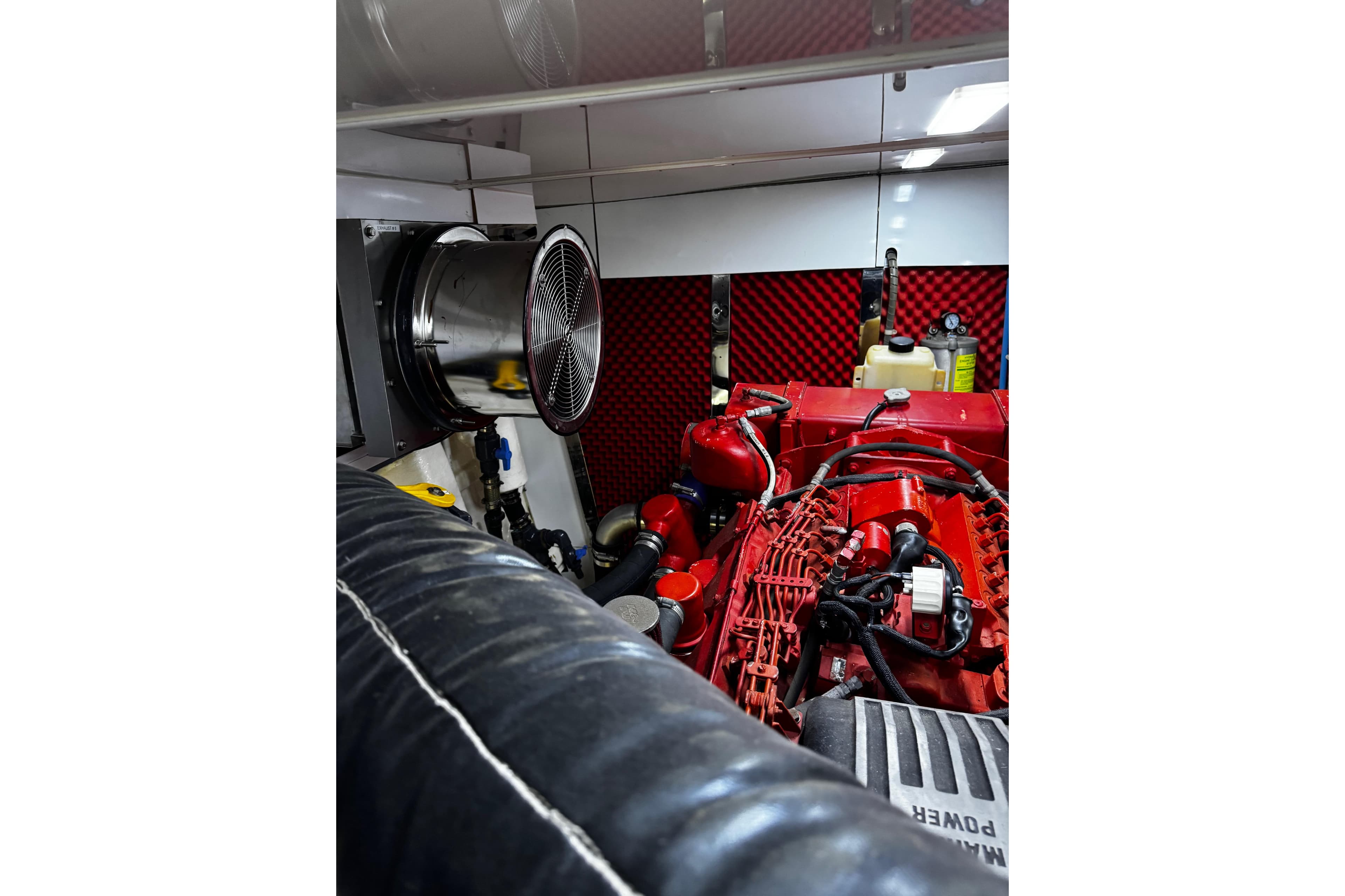 Engine room of 1996 Hershine Benship 87 yacht with red machinery and ventilation system.