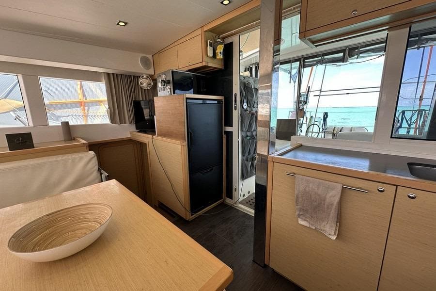 Interior of 2013 Lagoon 39 catamaran with modern kitchen and ocean view.