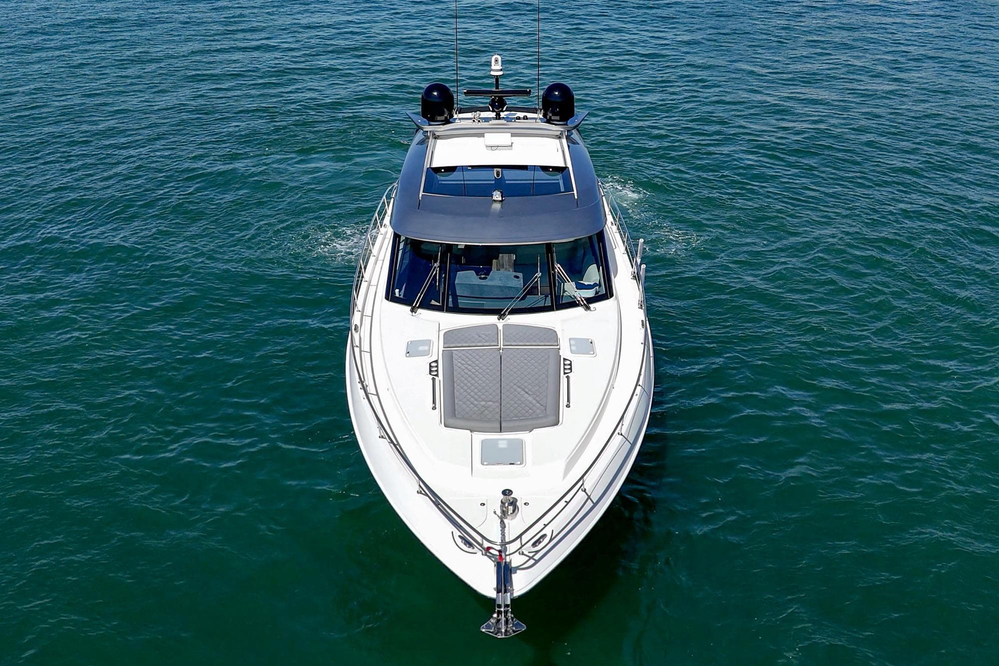 2024 Riviera 5400 Sport Yacht cruising on open water, aerial view.
