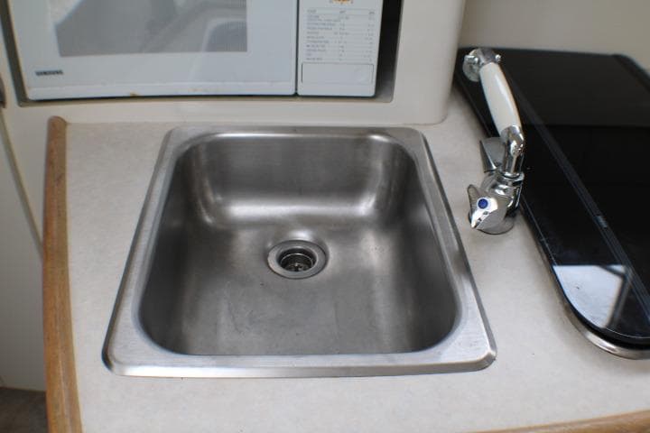Stainless steel sink in 1998 Bayliner 2655 Ciera Sunbridge boat kitchen area.