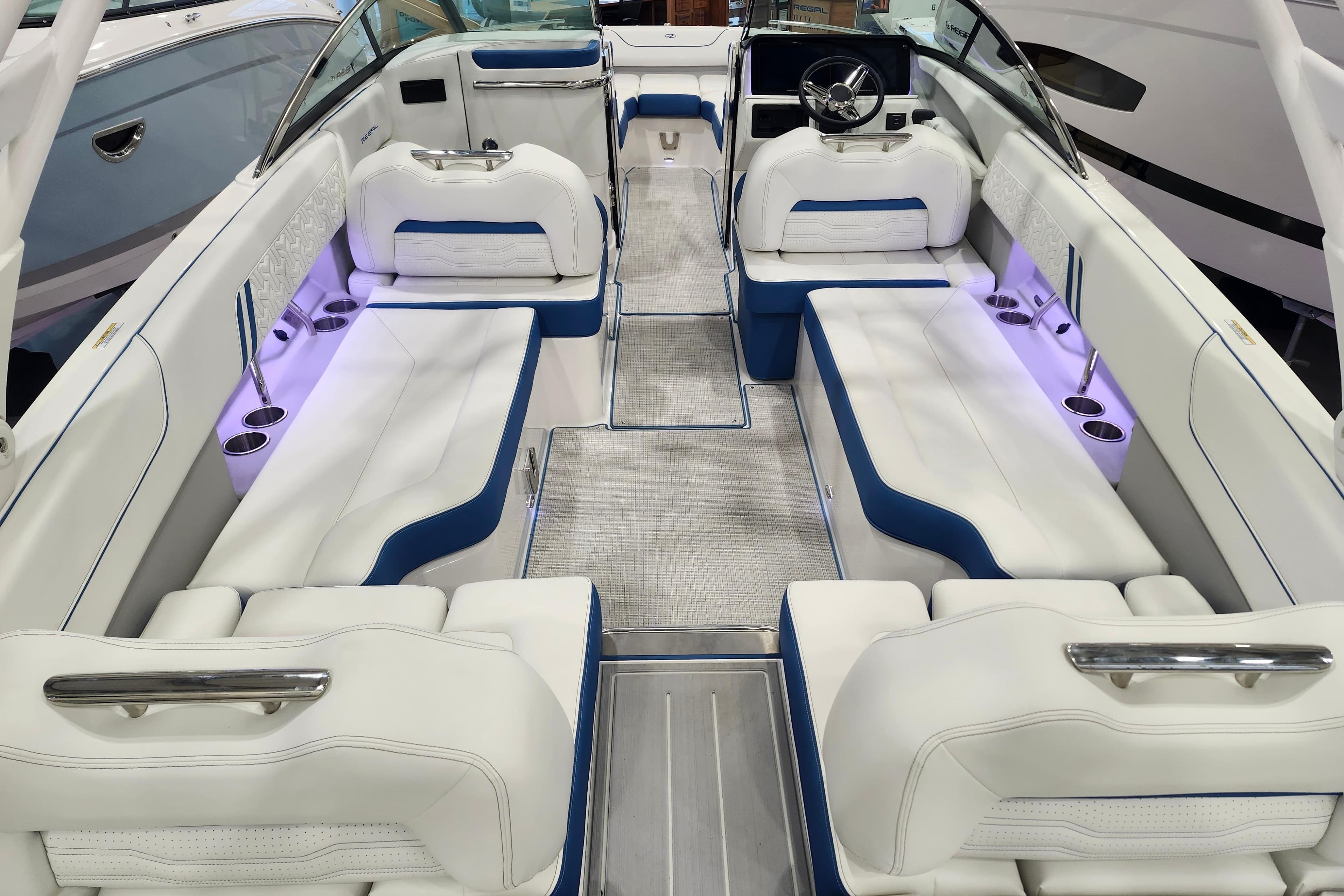 Luxurious interior of 2026 Regal LS6 Surf boat with white and blue seating.