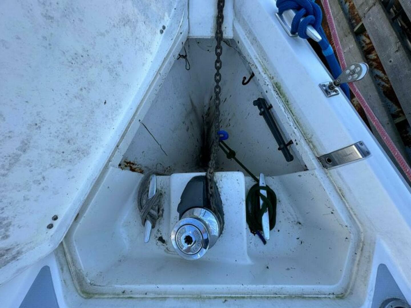 Anchor locker of a 1995 Hunter 430 sailboat with chain and cleats.