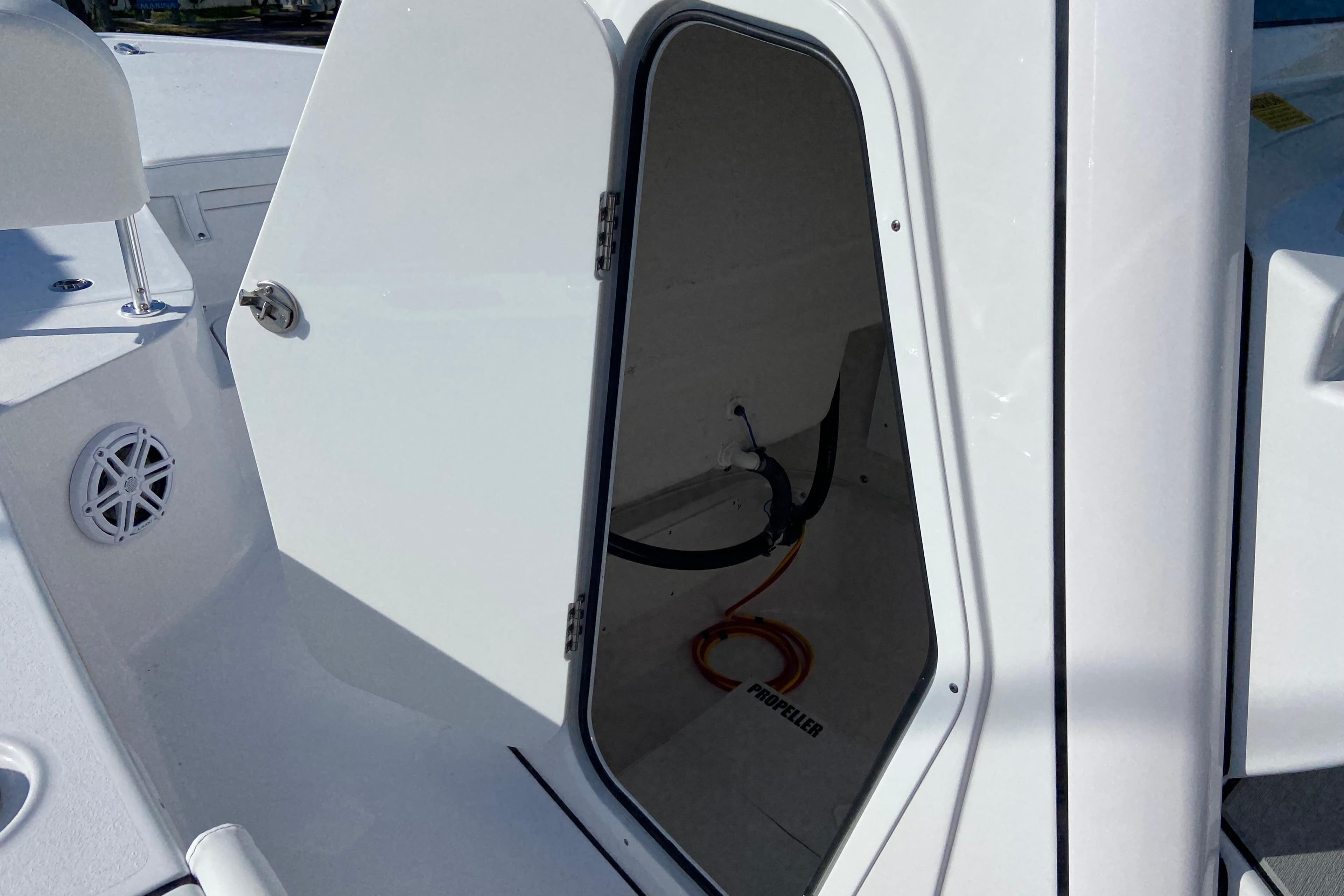 Open storage compartment on 2026 Sportsman Masters 227 Bay Boat, showcasing interior space.