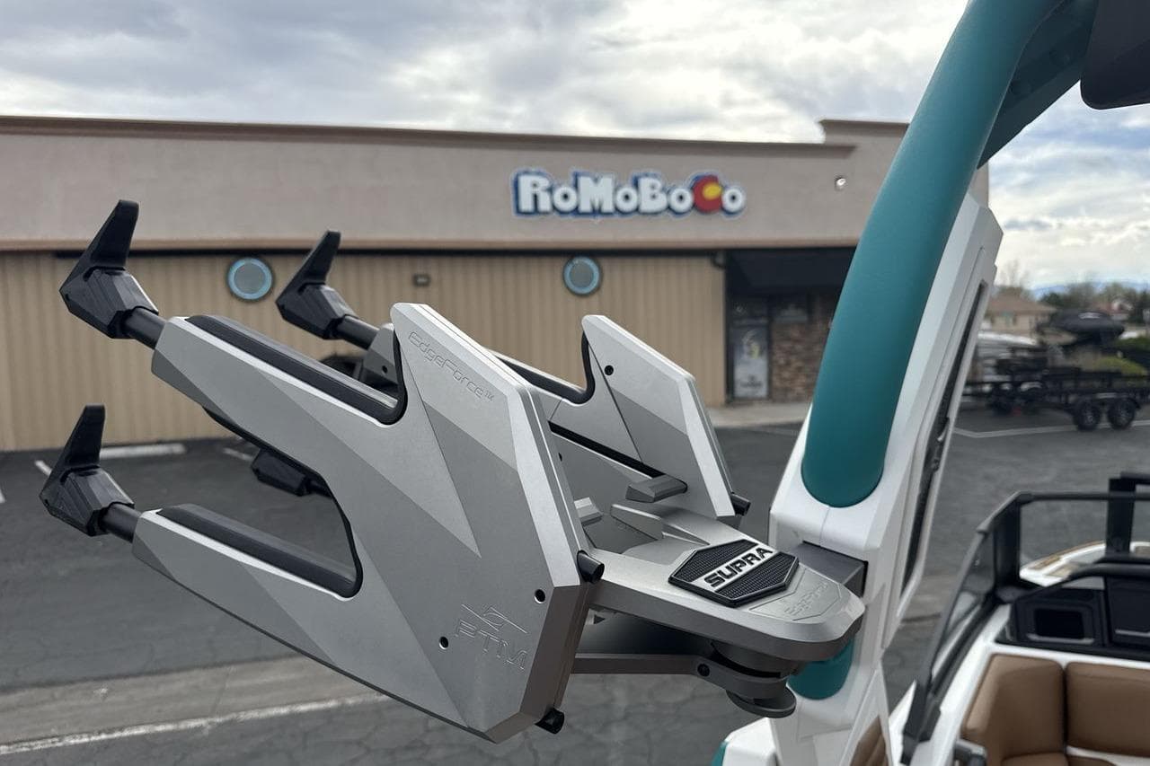 2026 Supra SV boat accessory in parking lot, with building in background.