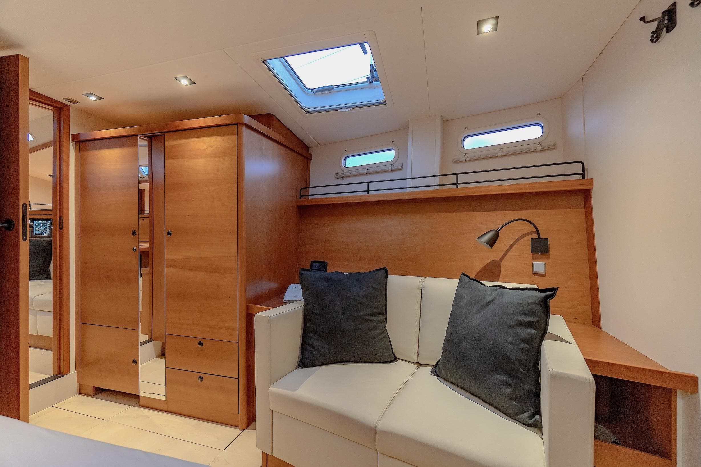 Luxurious interior of 2009 Hanse 630e yacht with cozy seating and modern wood finish.