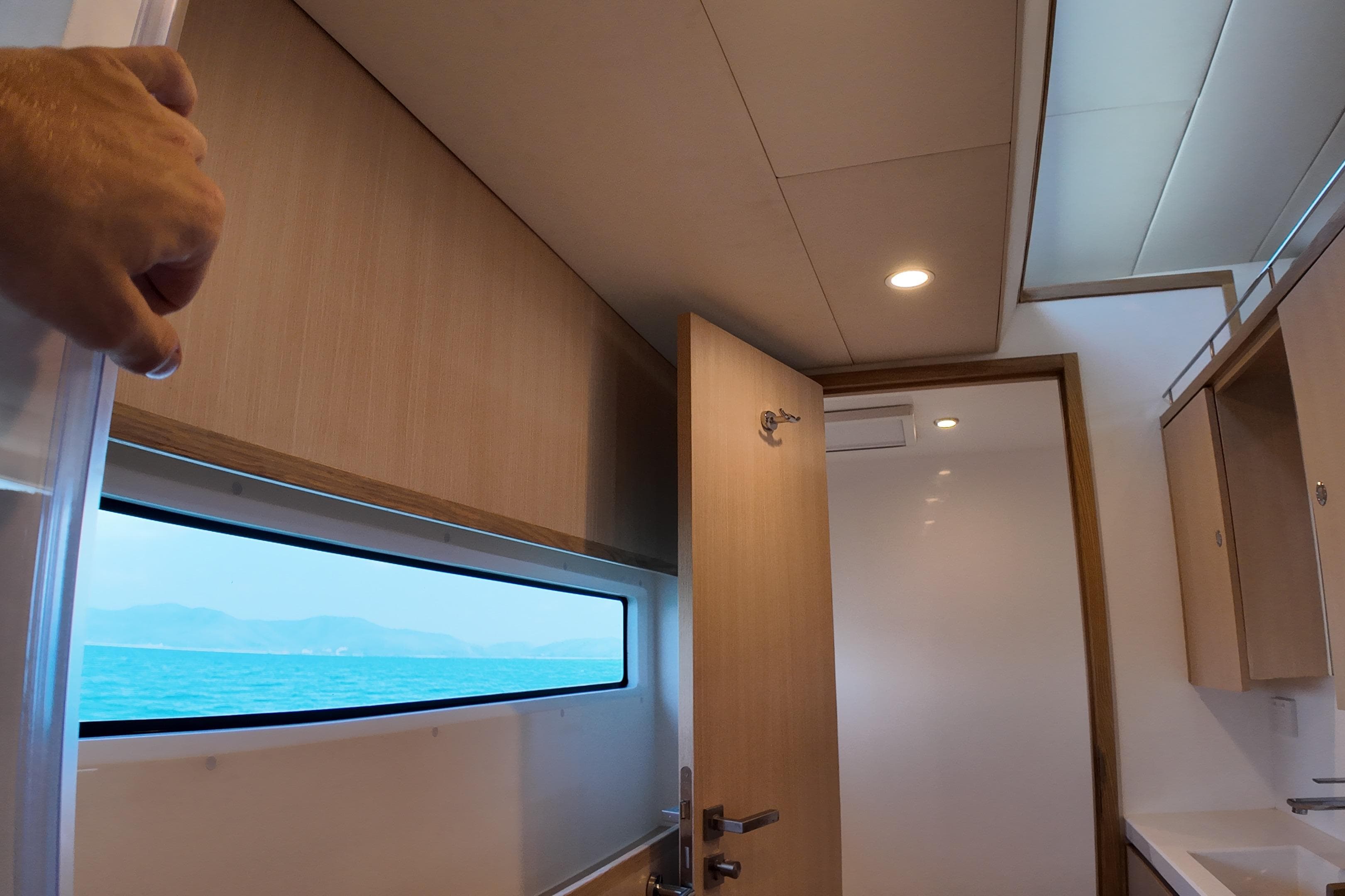 Interior of 2026 Longreach 58 yacht with ocean view window and modern design.