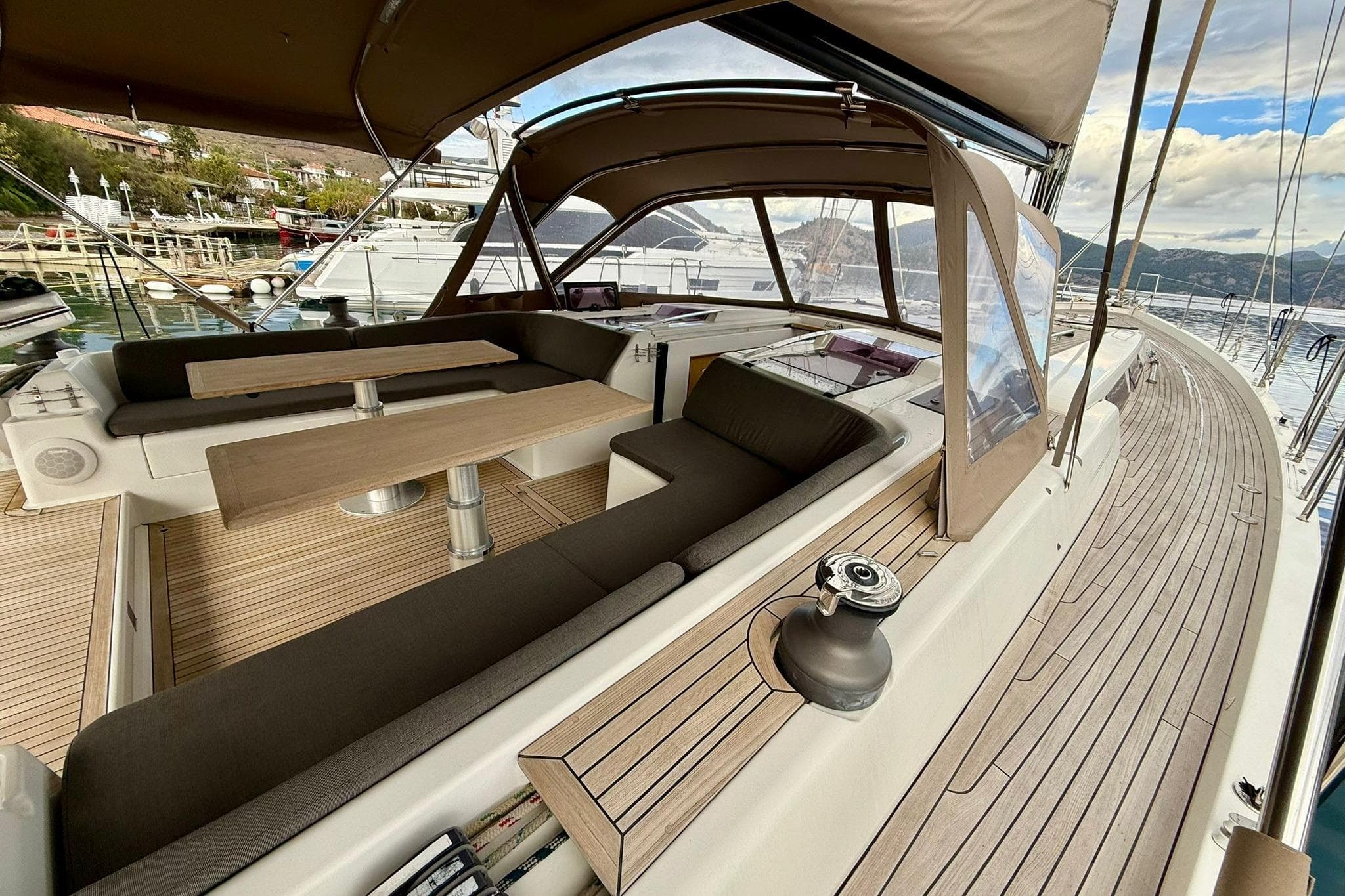 Luxurious 2012 Hanse 575 yacht with spacious deck and elegant seating area.