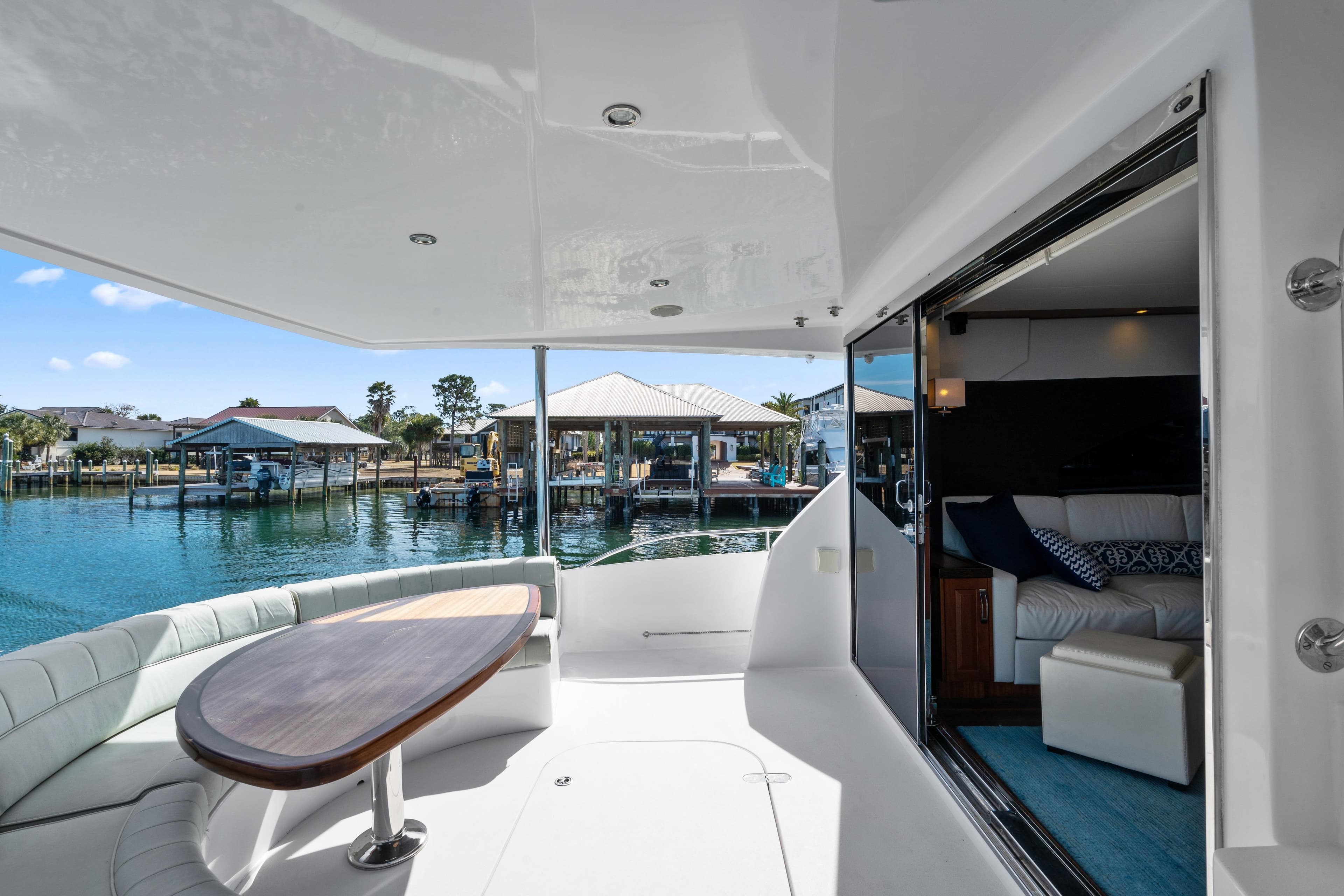 Luxurious 2013 Hatteras 60 Motor Yacht with elegant interior and scenic marina view.