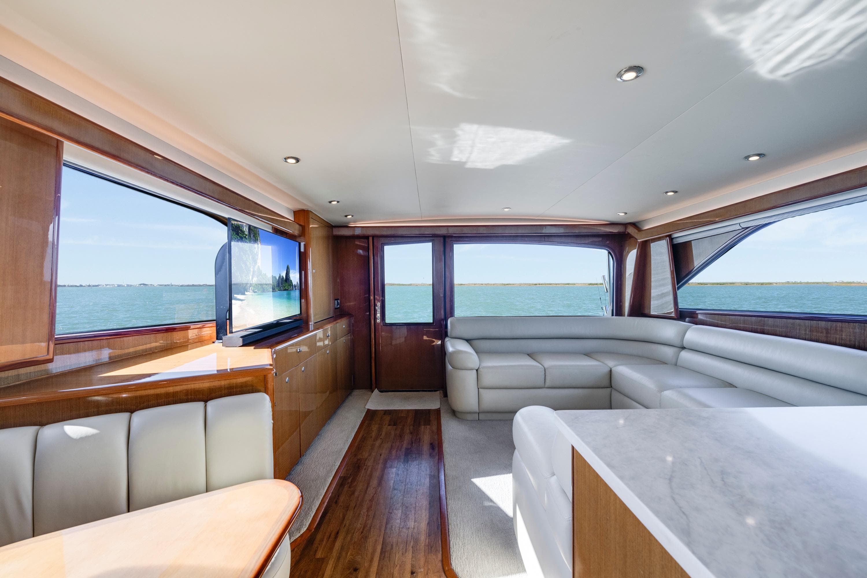 Luxurious interior of a 2002 Viking Convertible yacht with elegant seating and ocean views.