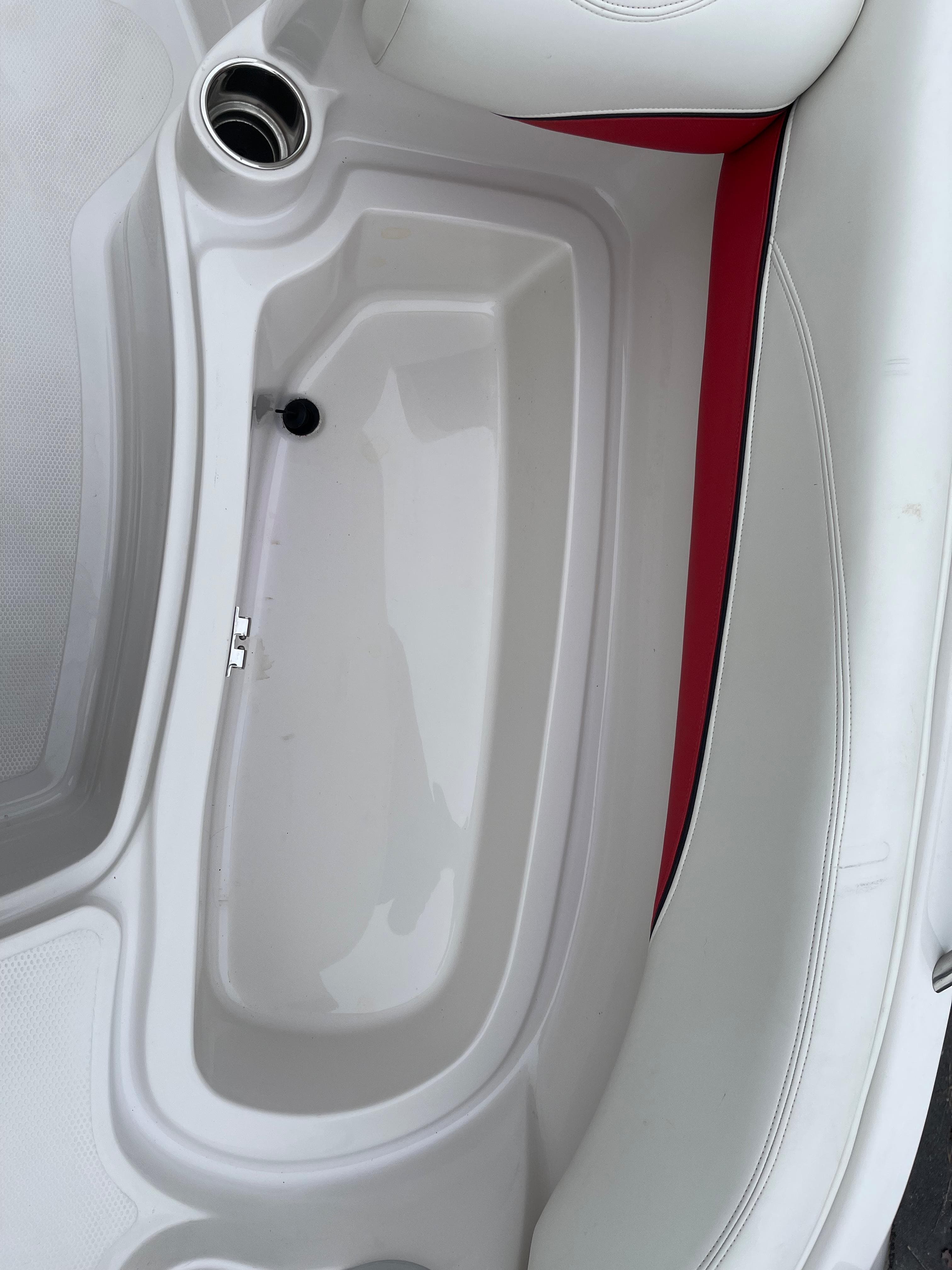 Interior of a 2016 Tahoe 215 Xi boat with white and red upholstery.