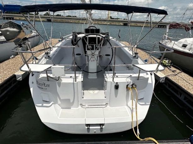 2017 Catalina 315 sailboat docked, featuring spacious cockpit and dual steering wheels.