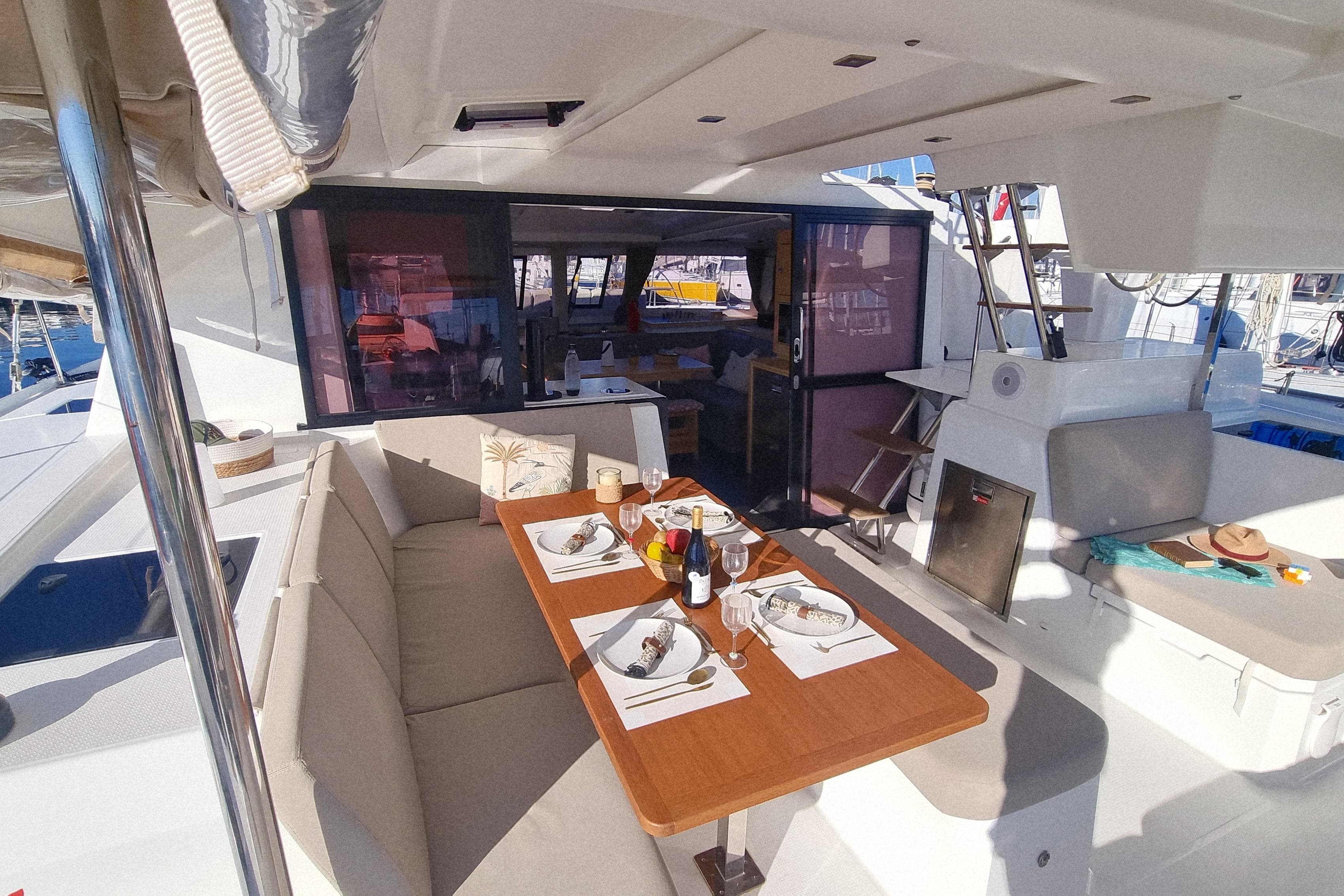2024 Fountaine Pajot Astrea 42 Catamaran with elegant outdoor dining setup.