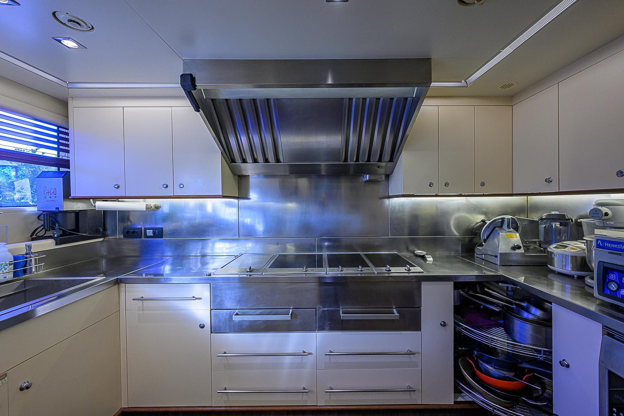 Luxurious kitchen in 2005 Benetti Vision 145 yacht, featuring stainless steel appliances and modern cabinetry.