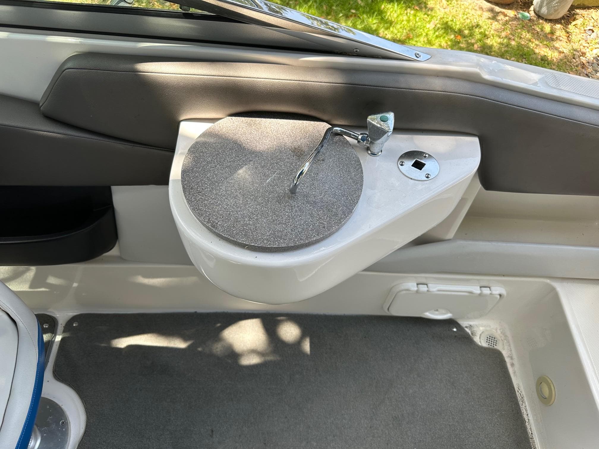 Interior of 2008 Regal 2250 Cuddy boat showing a compact sink and faucet.