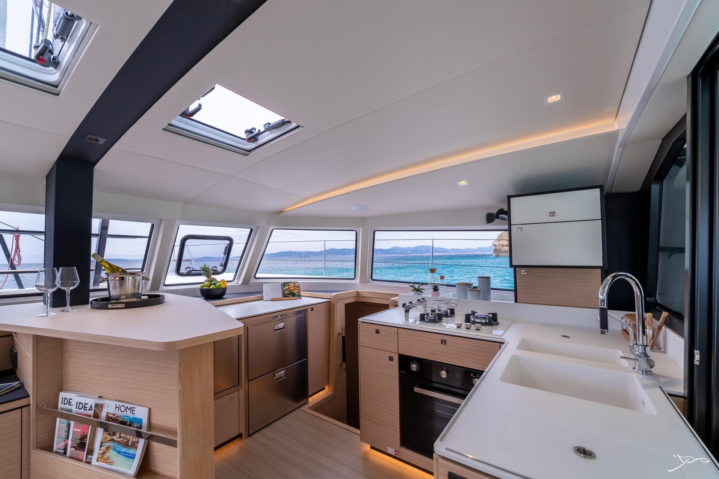 Luxurious interior of 2025 Nautitech 44 Open catamaran with modern kitchen and ocean view.