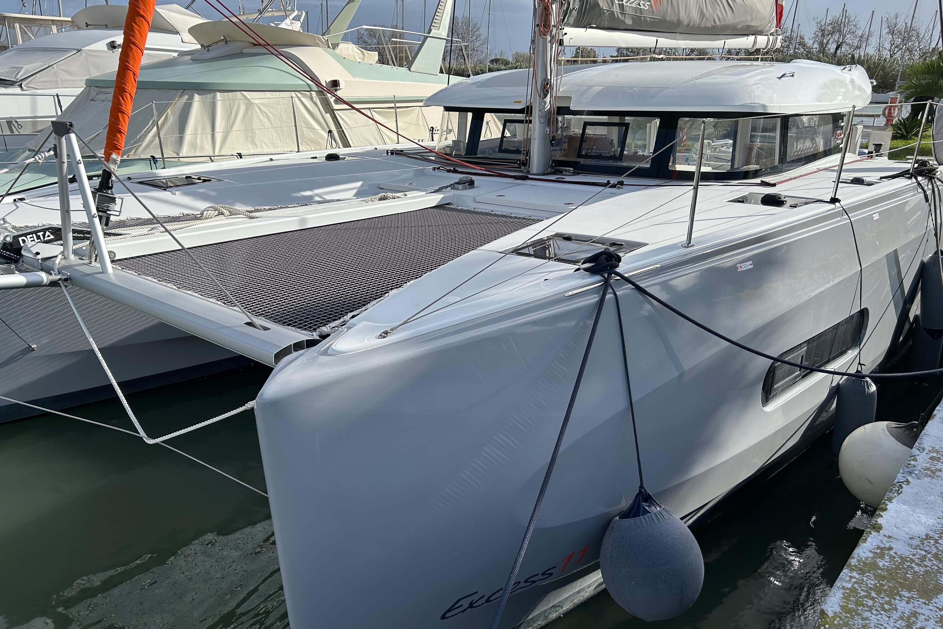2022 Excess 11 catamaran docked at marina, showcasing sleek design and modern features.
