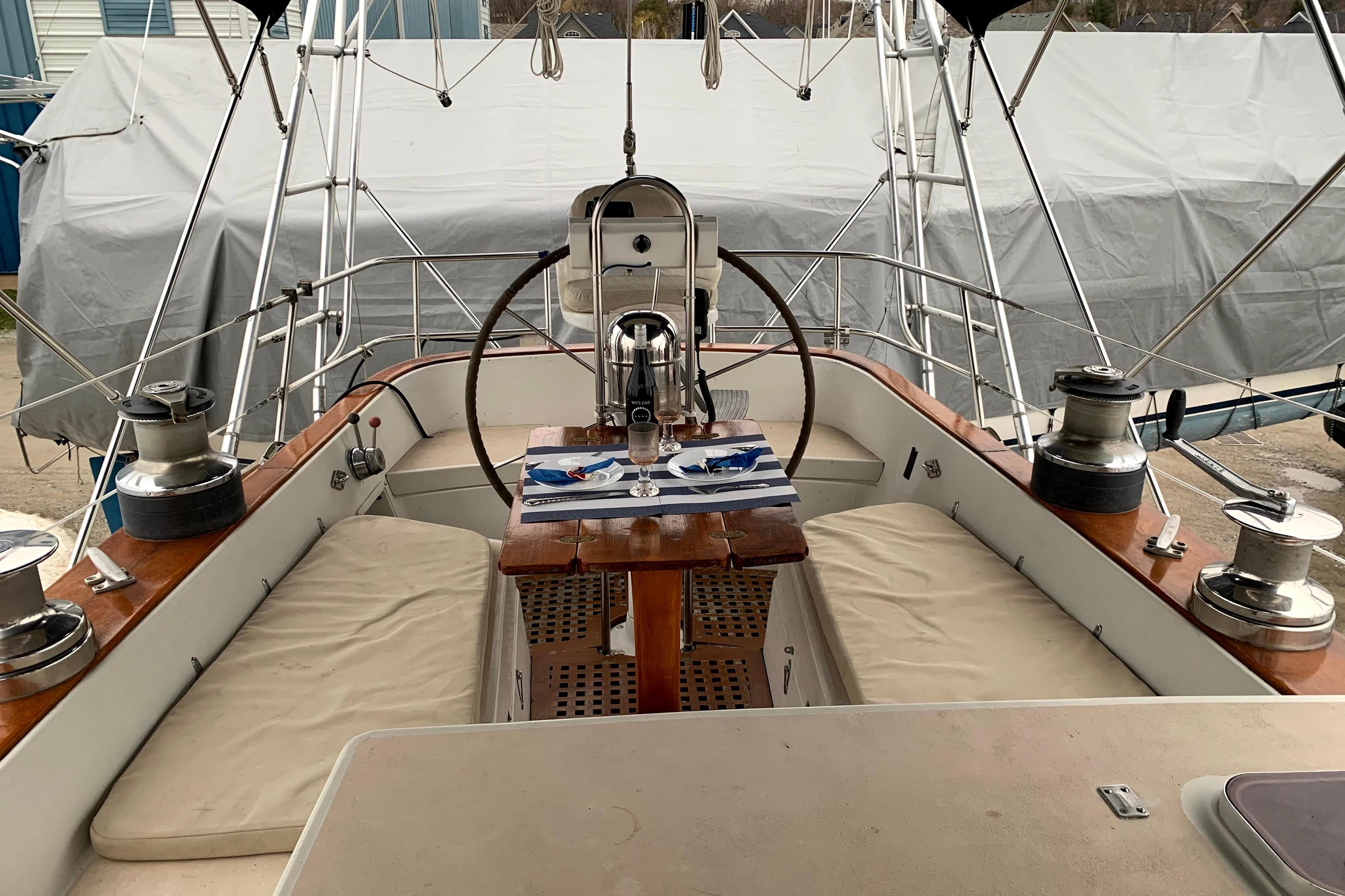 Cockpit of 1982 C&C Landfall 48 sailboat with wheel, winches, and seating.