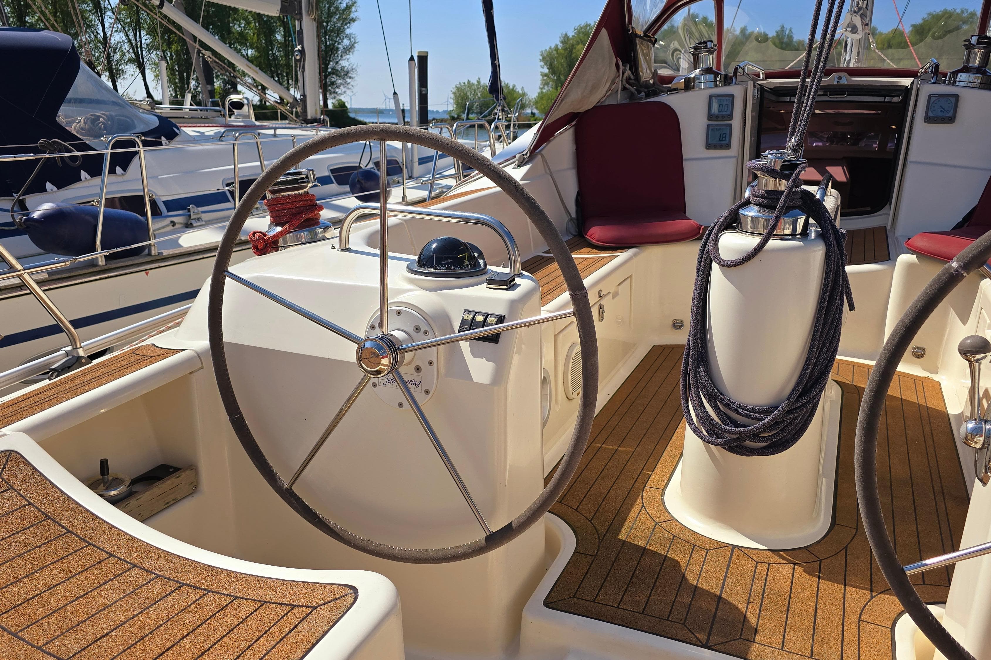 2007 Etap 46 DS yacht cockpit with steering wheel and teak flooring.