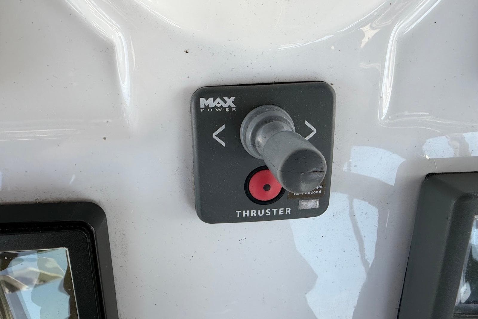 Control panel of a 2009 Hunter 50 Center Cockpit boat with thruster joystick.