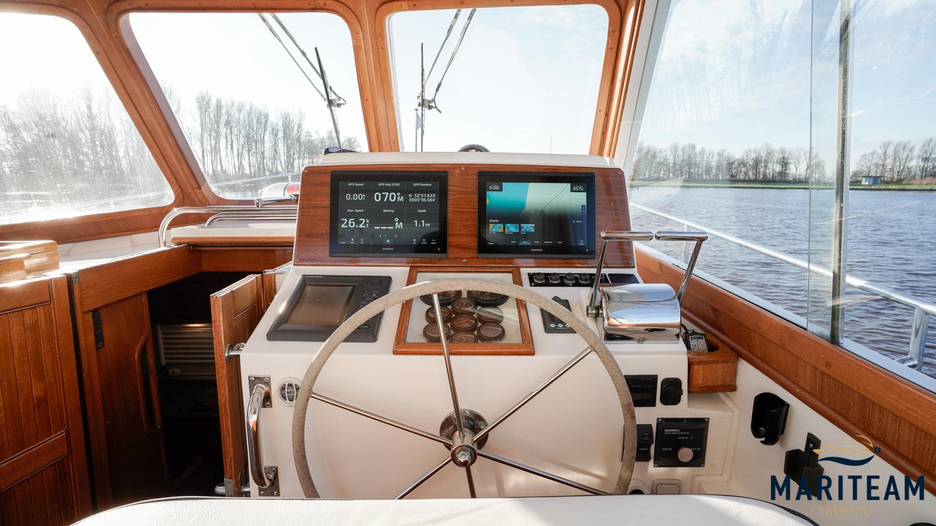 Helm of 2000 Grand Banks Eastbay 38 HX yacht with modern navigation equipment.