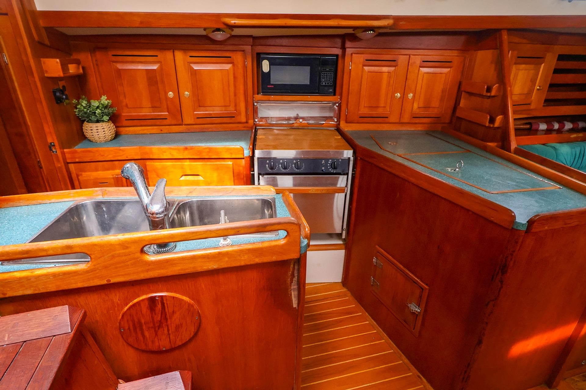 2001 Tartan 4100 yacht kitchen with wooden cabinetry and modern appliances.