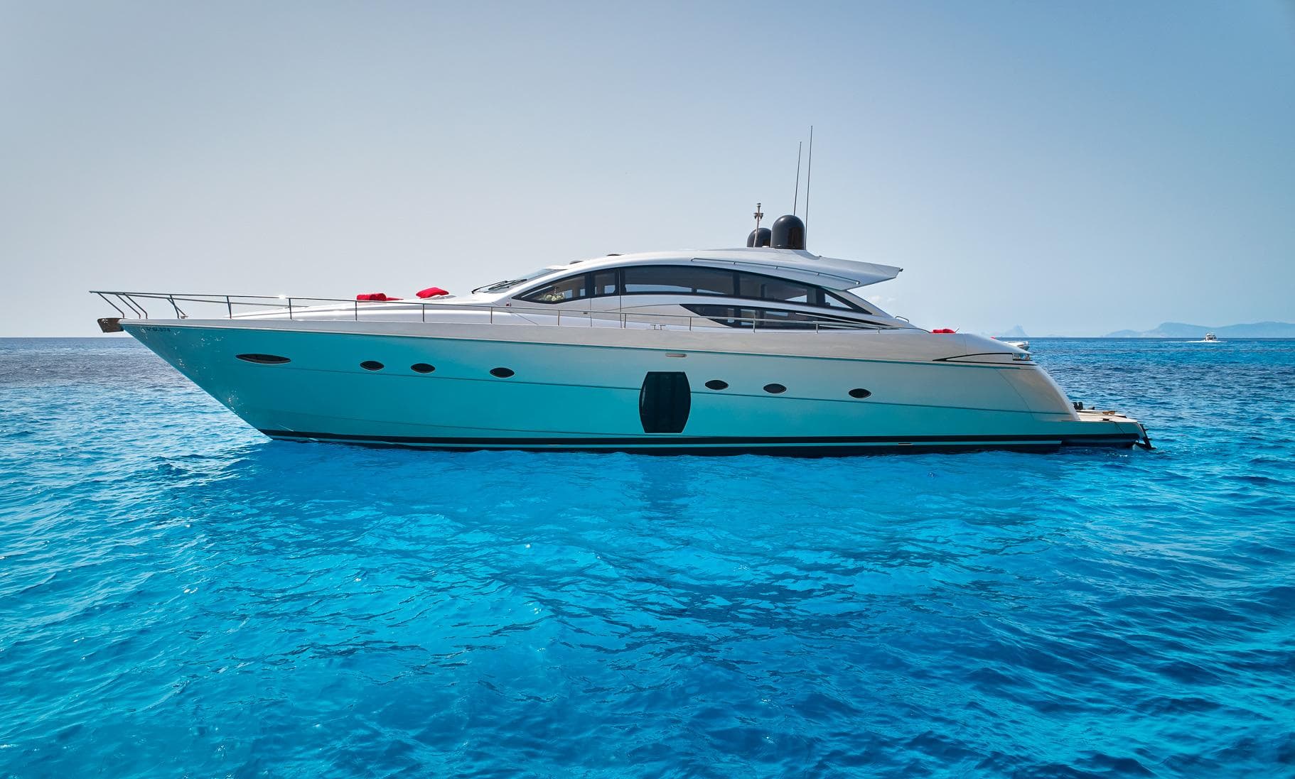 2007 Pershing 72 yacht on clear blue ocean water.