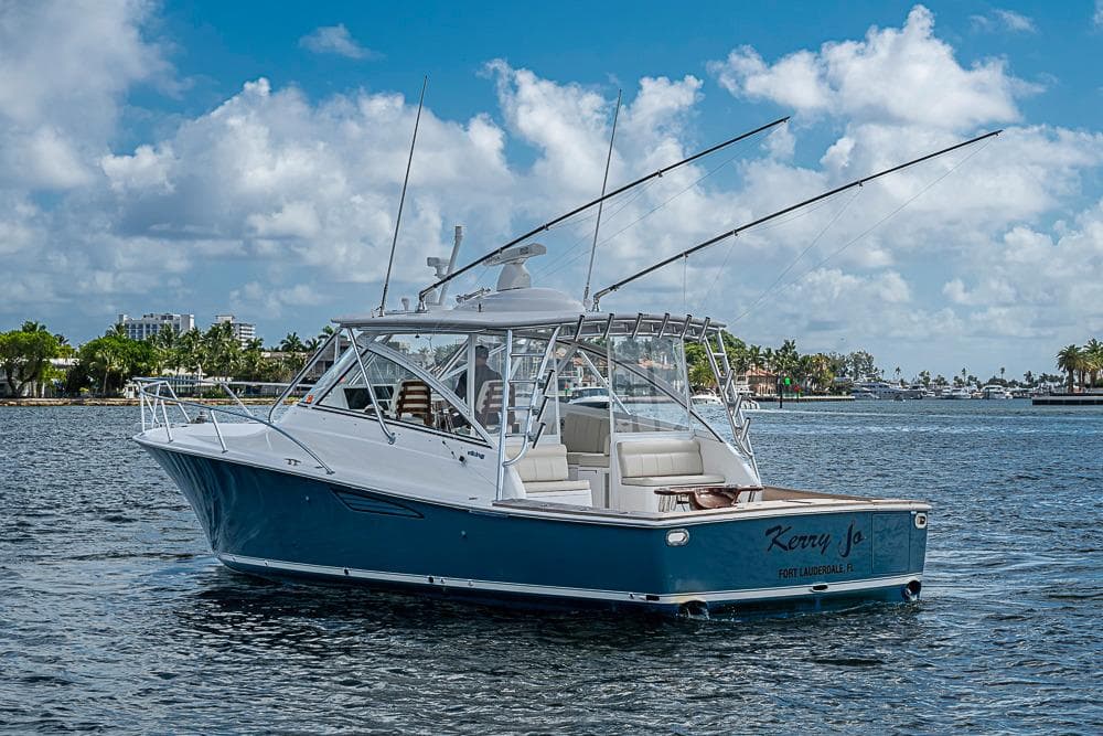 2021 Viking 38 Open yacht on water, clear sky, Fort Lauderdale backdrop.