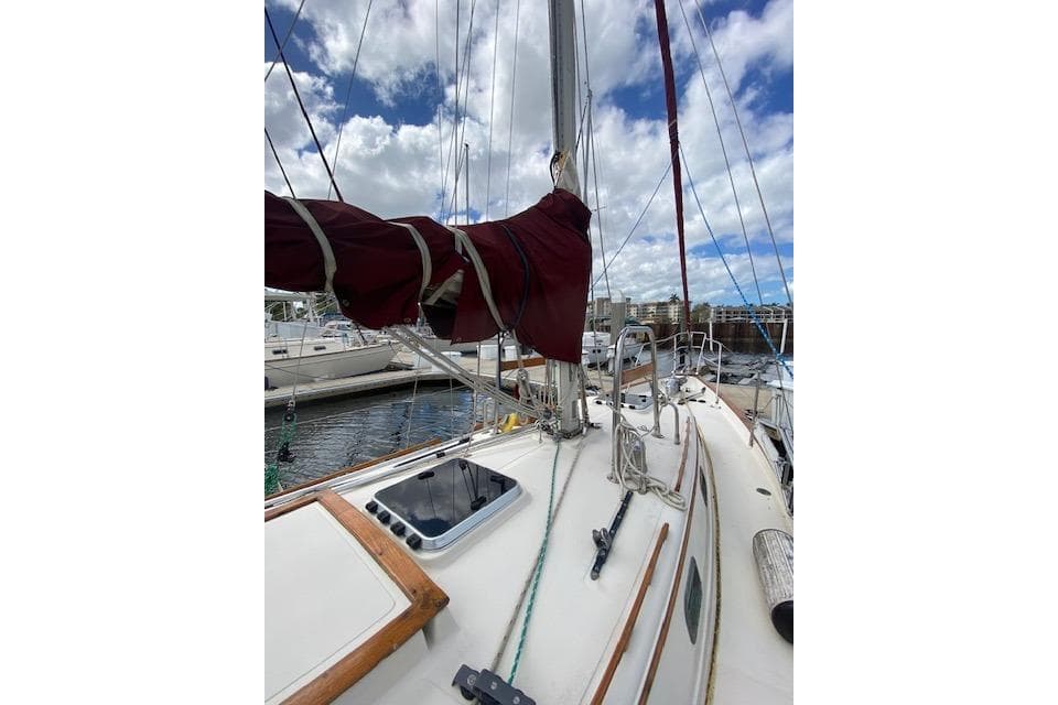 Sailboat deck view of 1995 Pacific Seacraft Crealock 34 with rigging and cloudy sky.