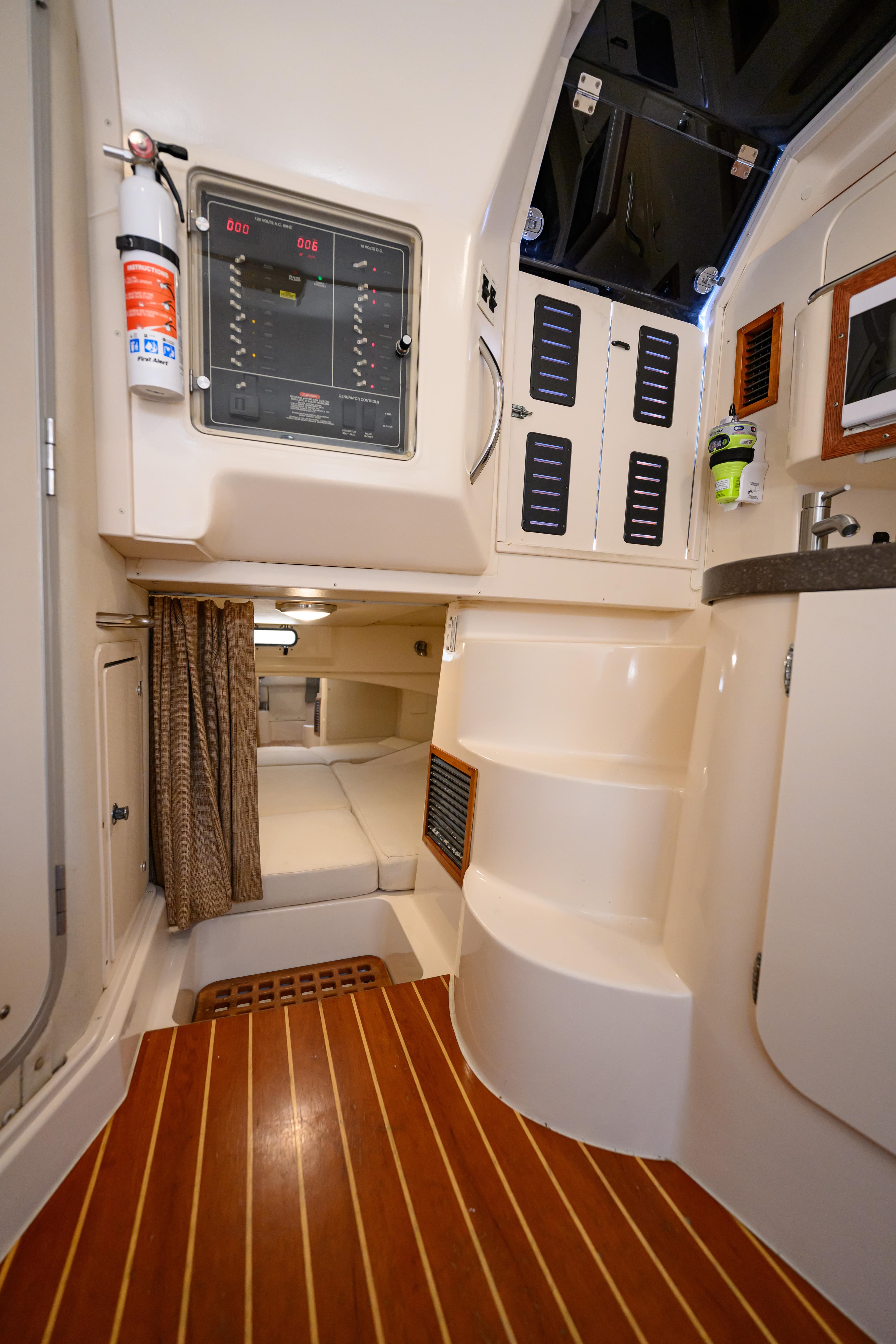 Interior of 2003 Grady-White Express 330 boat, featuring cabin, control panel, and wooden flooring.