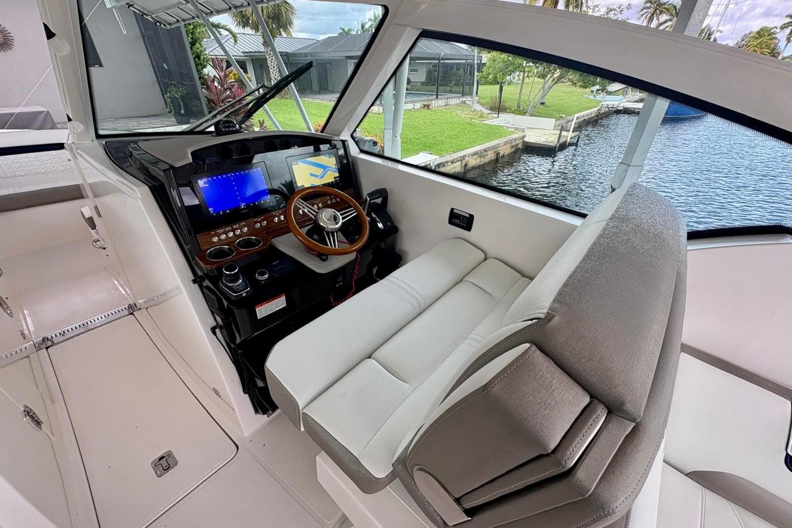 2024 Tiara Yachts 34 LX helm with modern controls and plush seating.