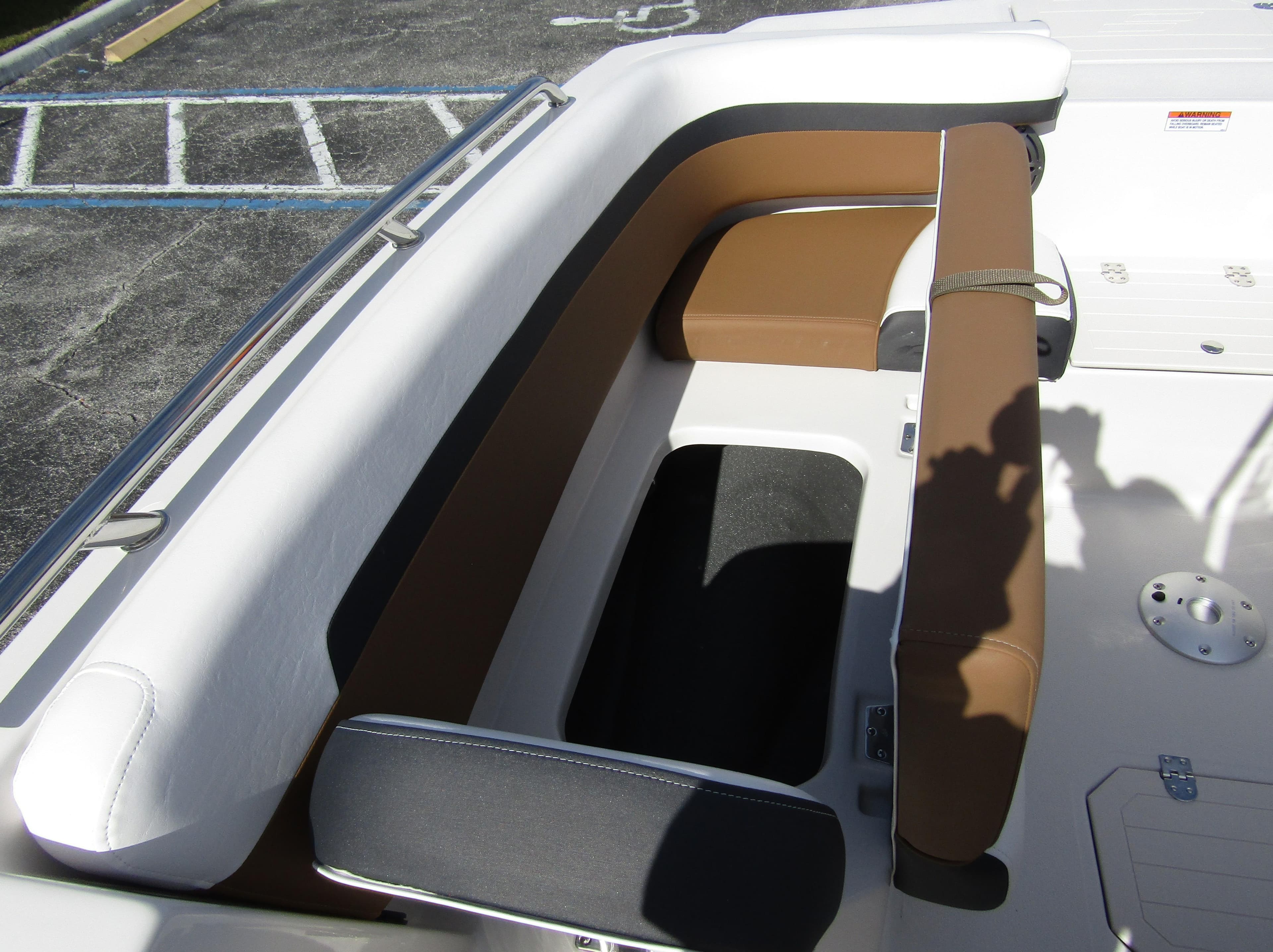 2024 Starcraft SVX 191 OB CC boat seating area with brown and white cushions.