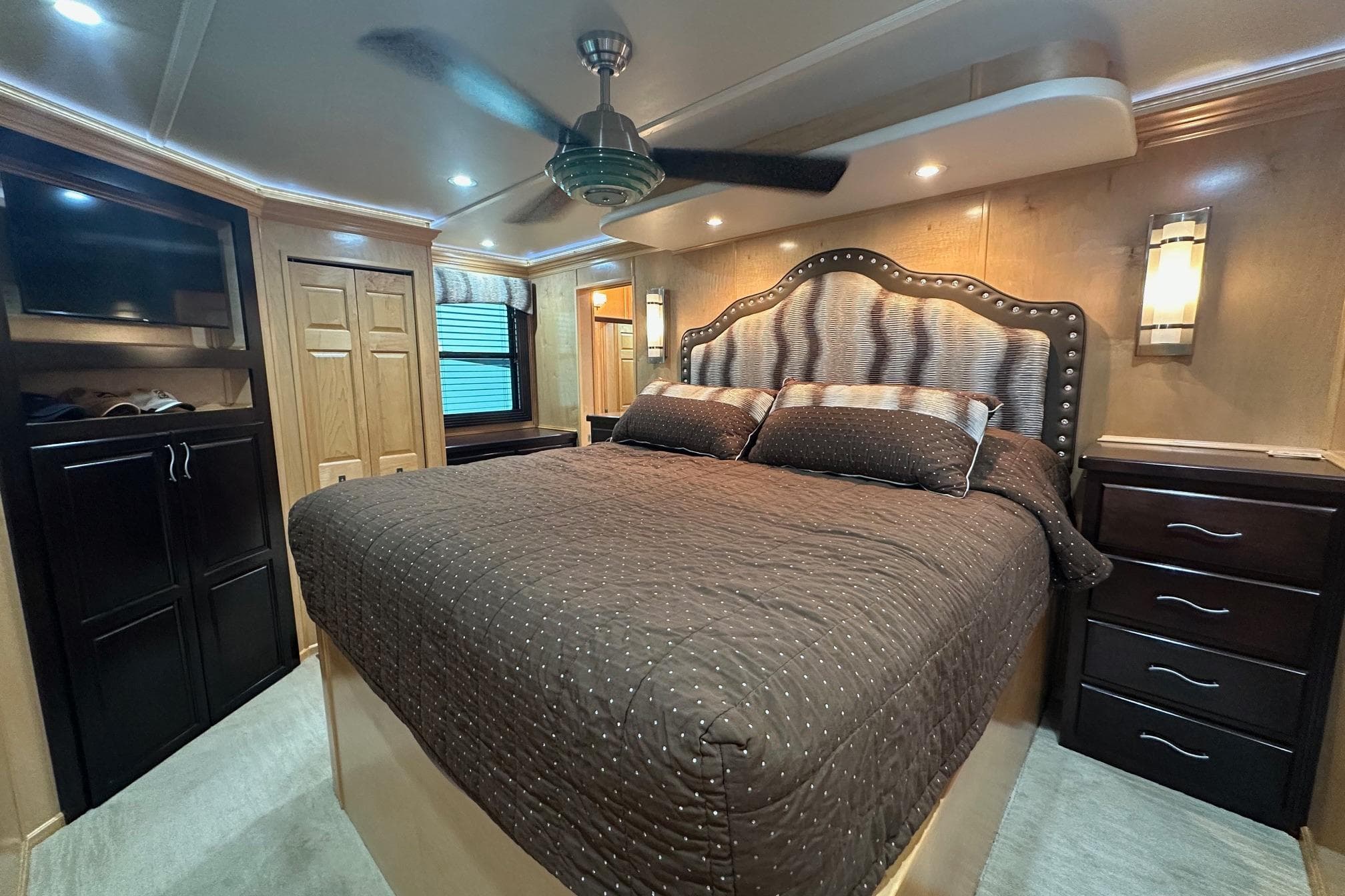 Luxurious bedroom interior of 2013 Sumerset 18x85 houseboat with elegant furnishings and ambient lighting.