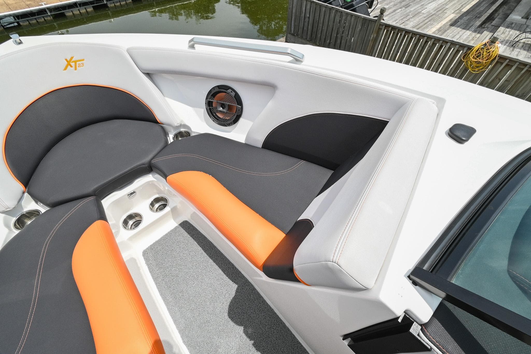 2018 MasterCraft XT23 boat interior with orange and gray seating.