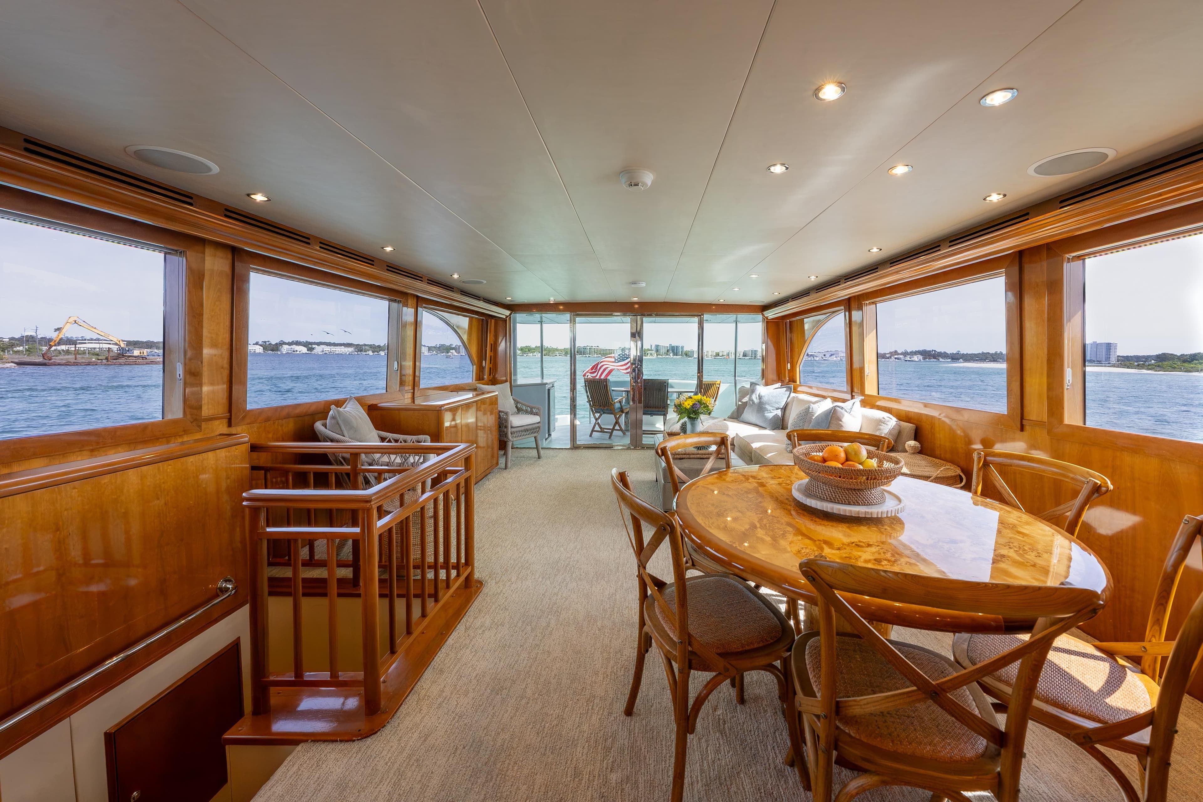 Luxurious interior of 2004 Hatteras 75 Sport Deck Motor Yacht with elegant dining area.