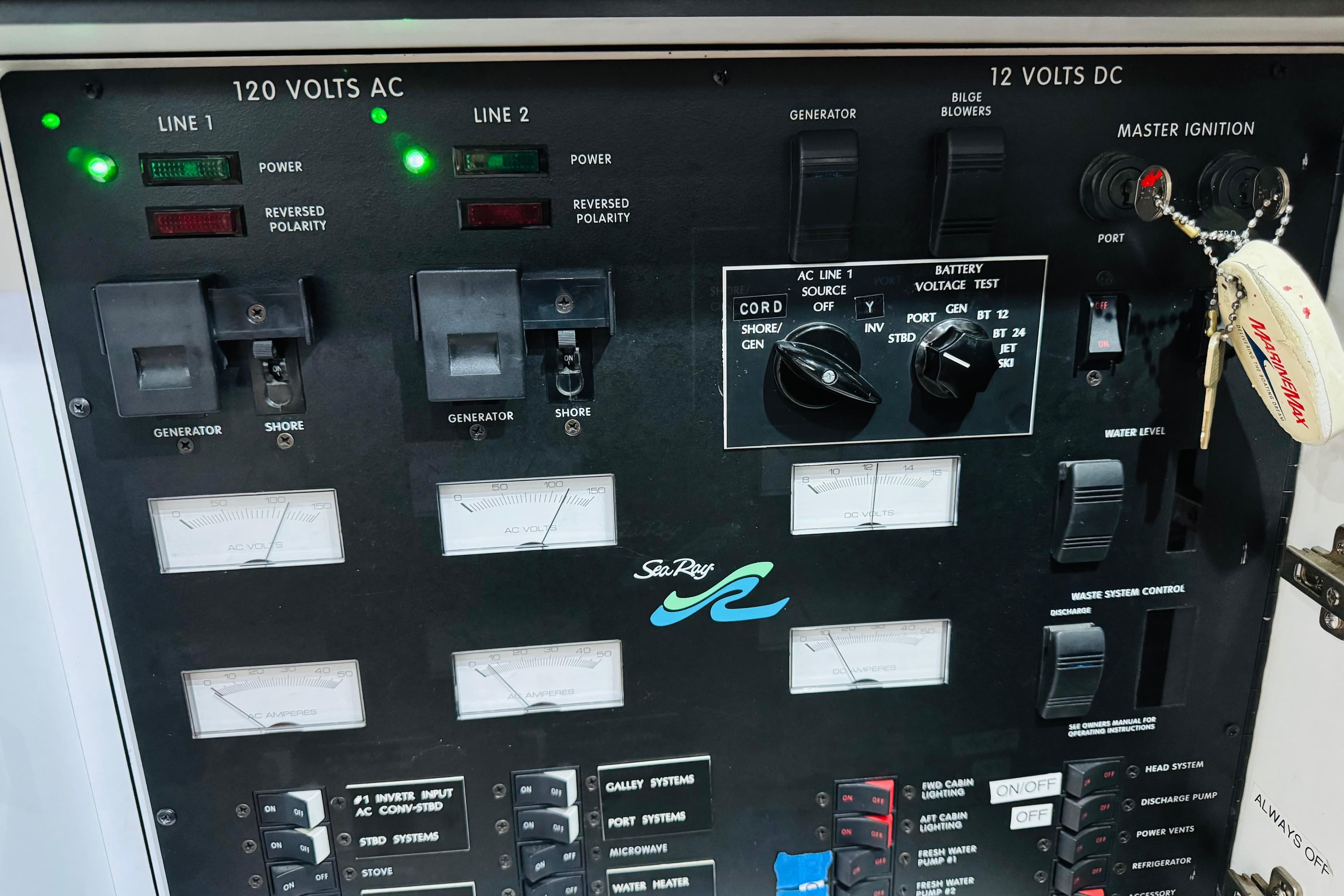 Control panel of a 1999 Sea Ray 400 Sedan Bridge boat, featuring electrical switches and gauges.