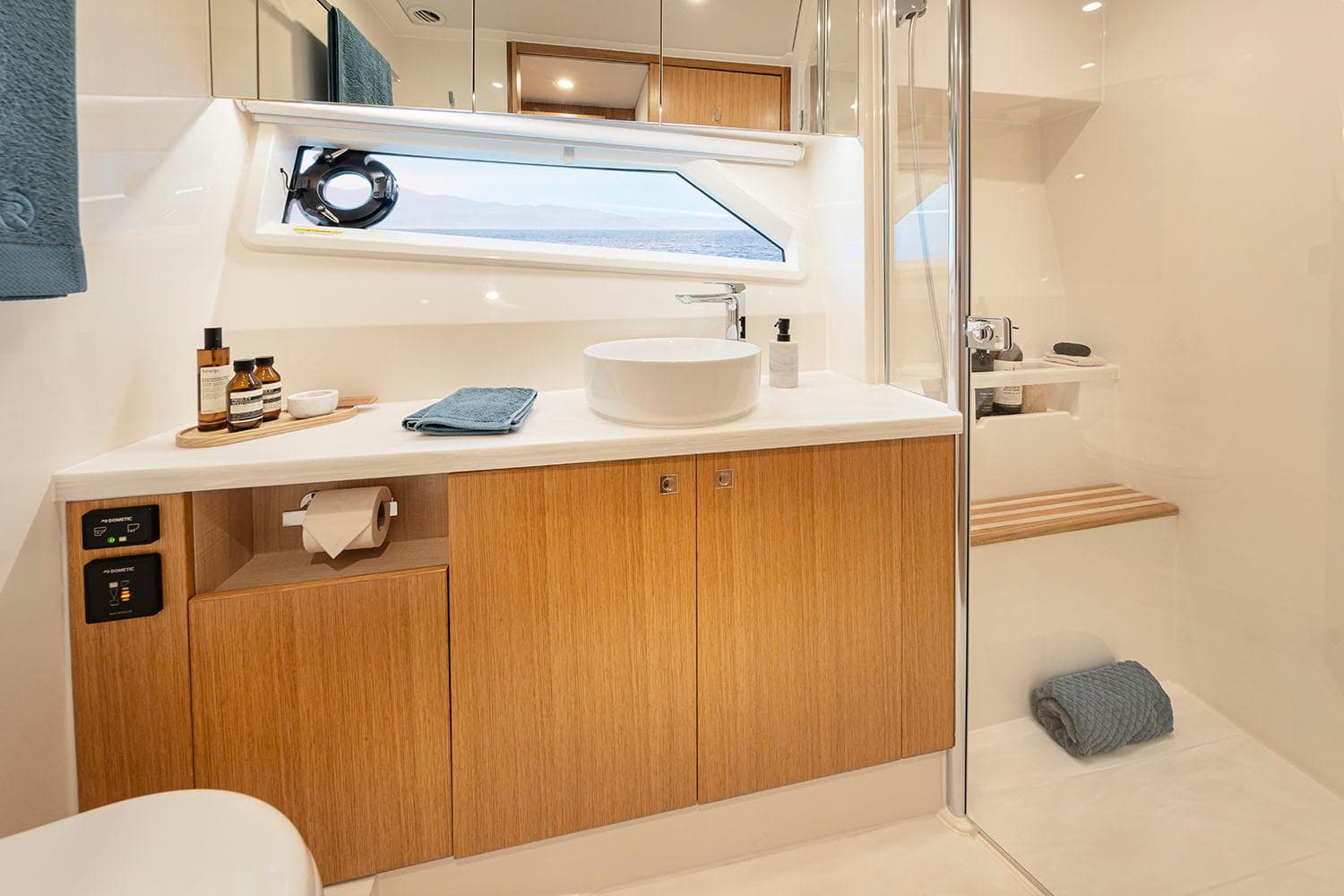 Manufacturer Provided Image: Luxurious bathroom in 2025 Riviera 585 SUV yacht with modern fixtures and wooden cabinetry.