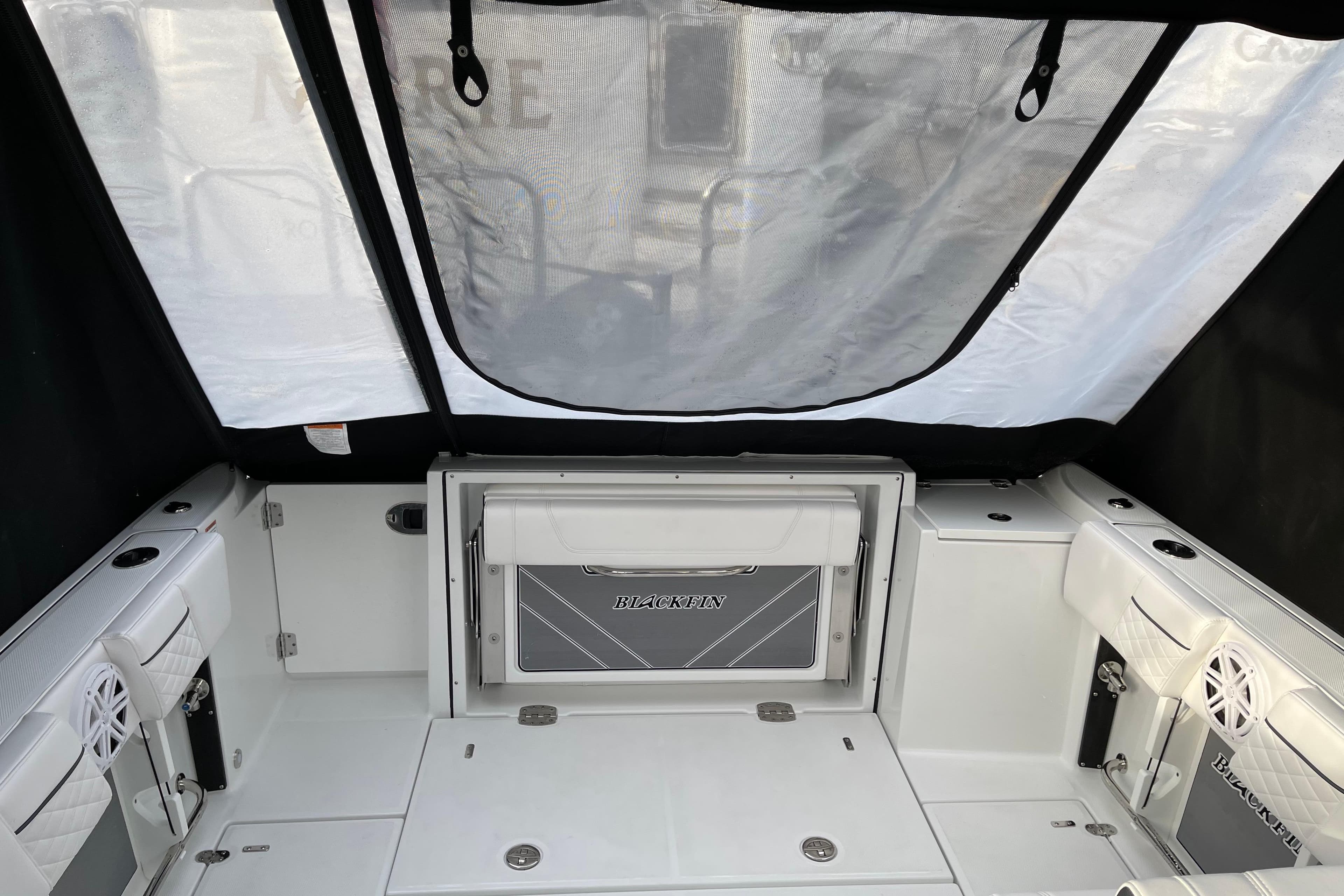 2021 Blackfin 252DC boat interior with seating and storage compartments.