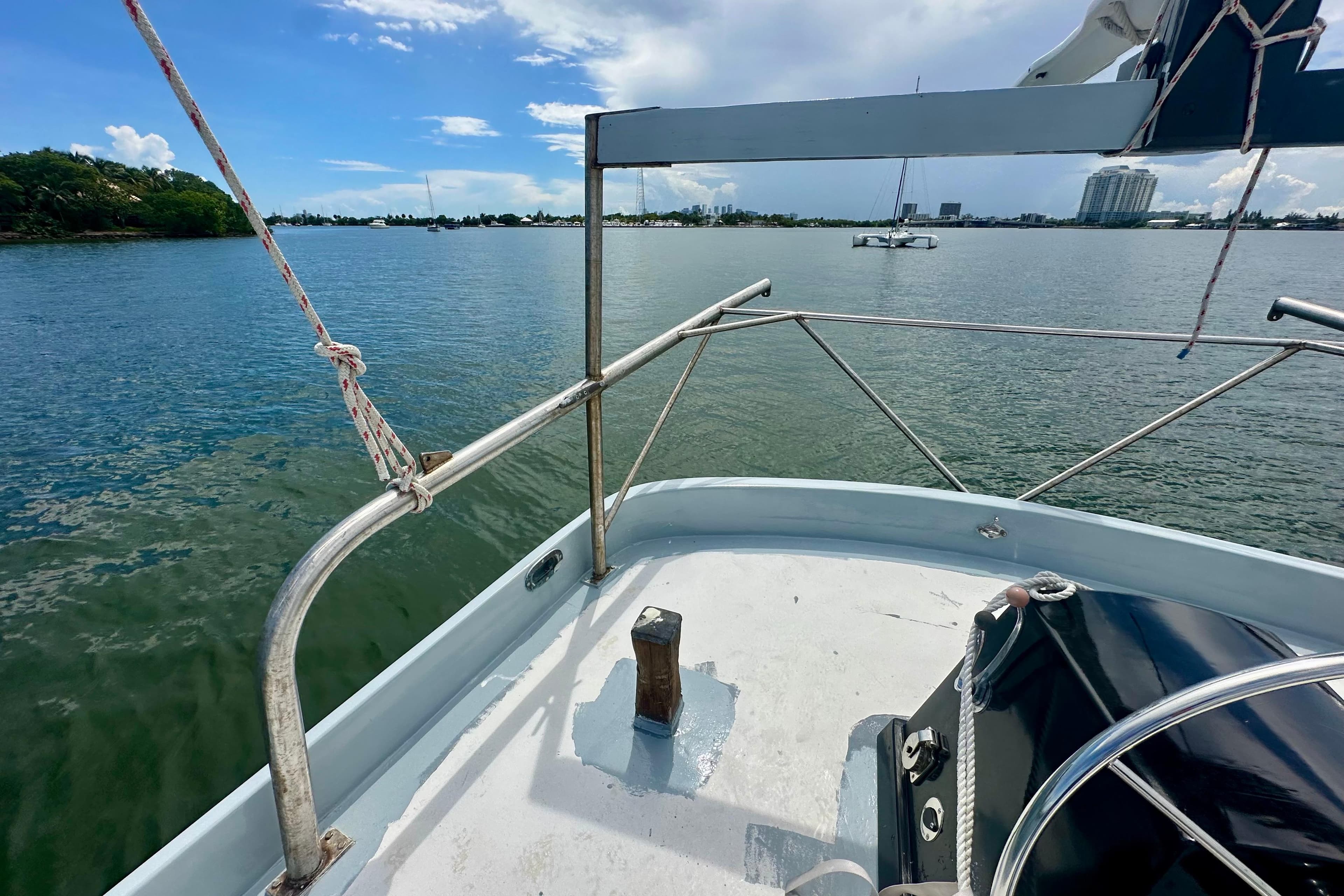 Schooner Leopard 1994 sailing on calm waters with city skyline in background.
