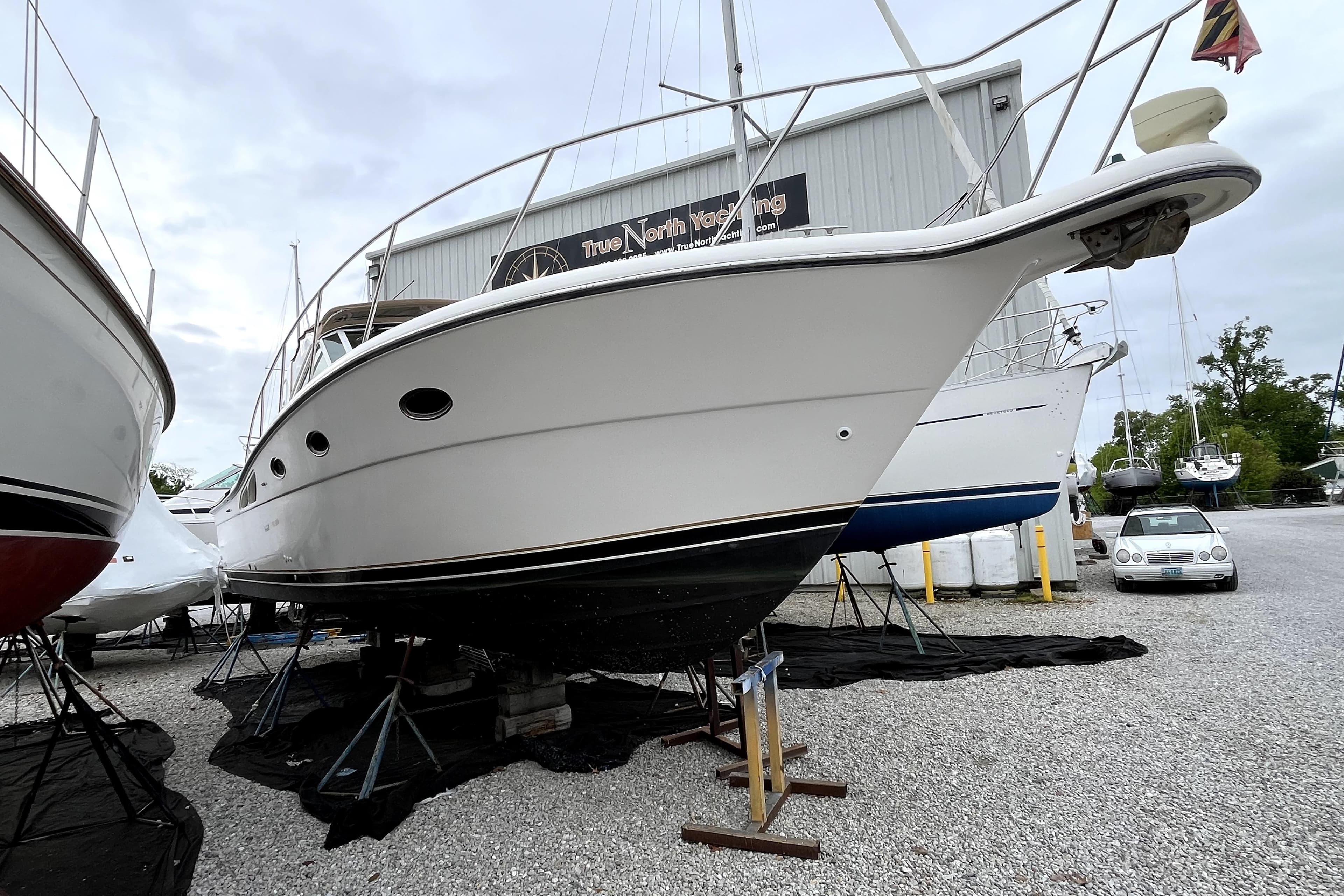 1999 Tiara Yachts 3500 Open on stands at a marina, ready for maintenance.