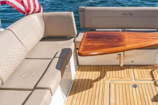 2017 Sea Ray 460 Sundancer yacht with elegant seating and wooden table on deck.