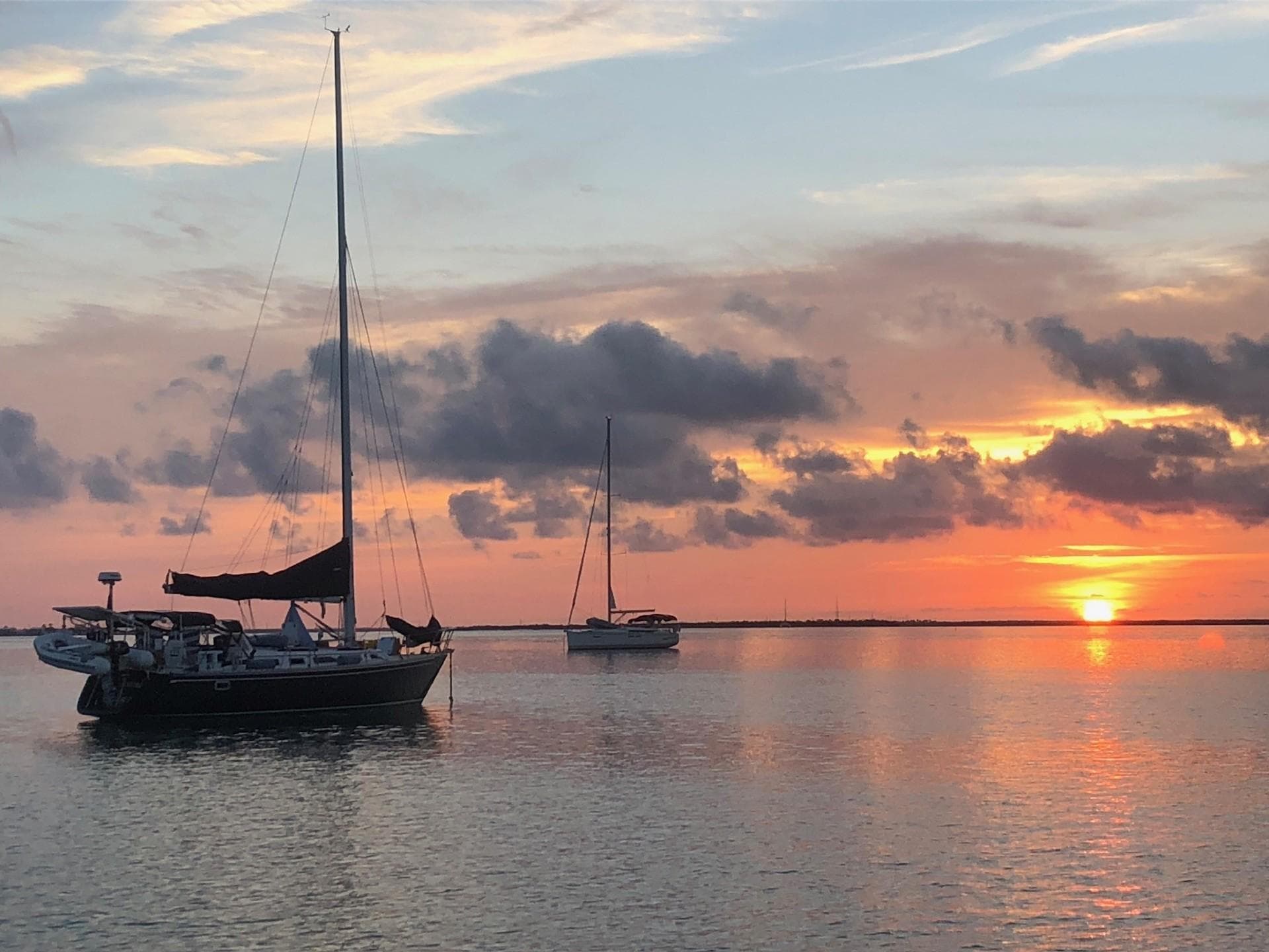 1991 Freedom F-38 sailboat at sunset on calm waters.