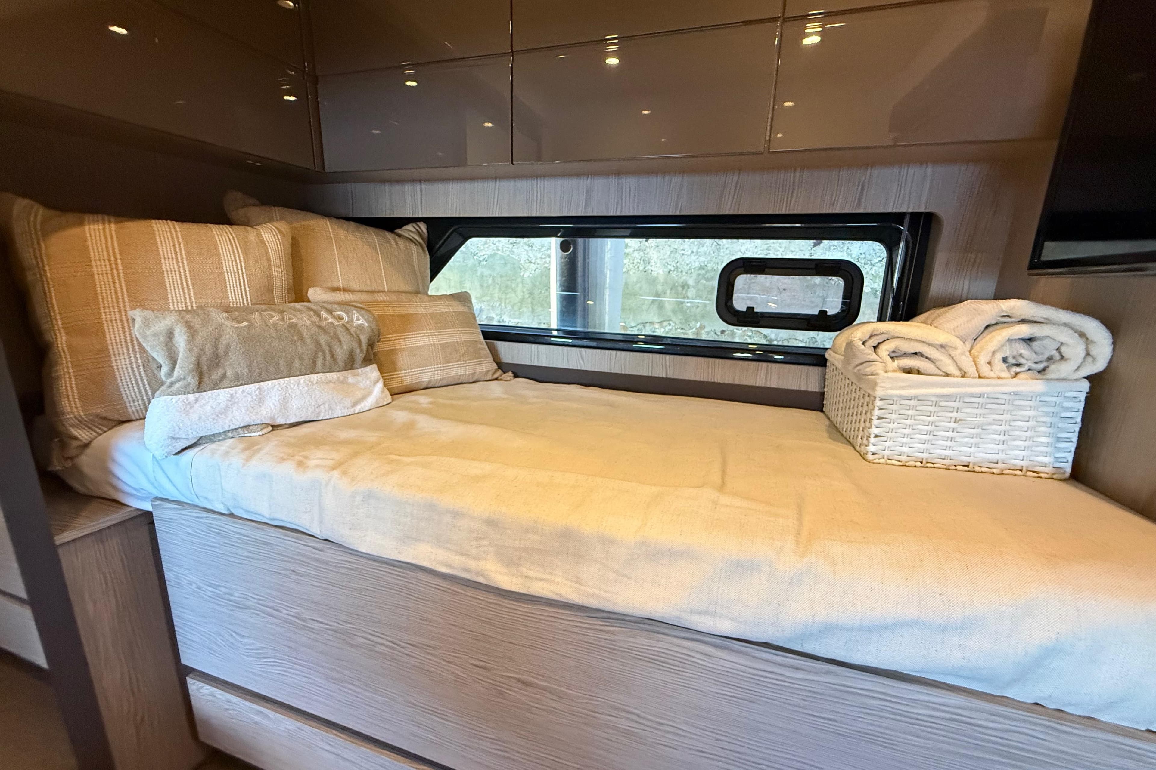 Cozy cabin interior of 2018 Azimut Atlantis 43 yacht with bed and window view.