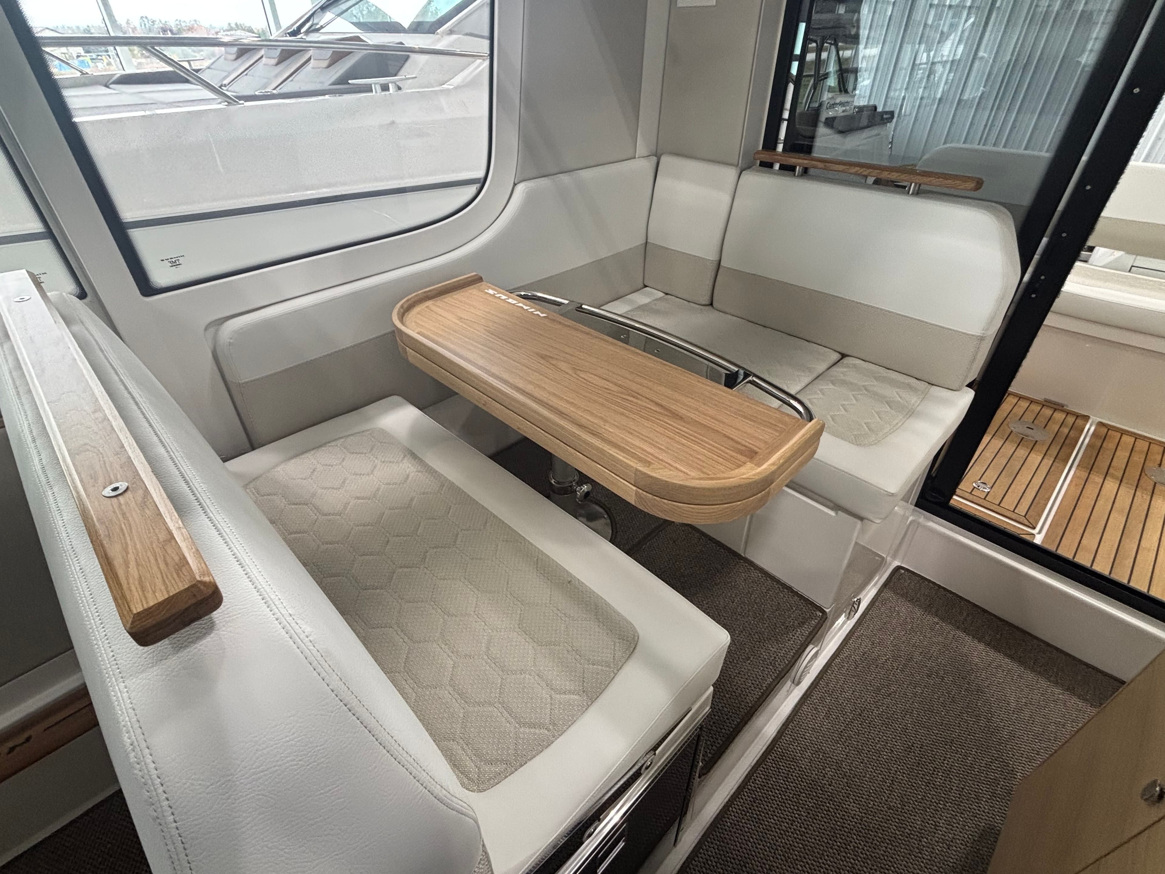 Interior of 2026 Nimbus Commuter 11 MKII Legacy Edition with elegant seating and wooden table.