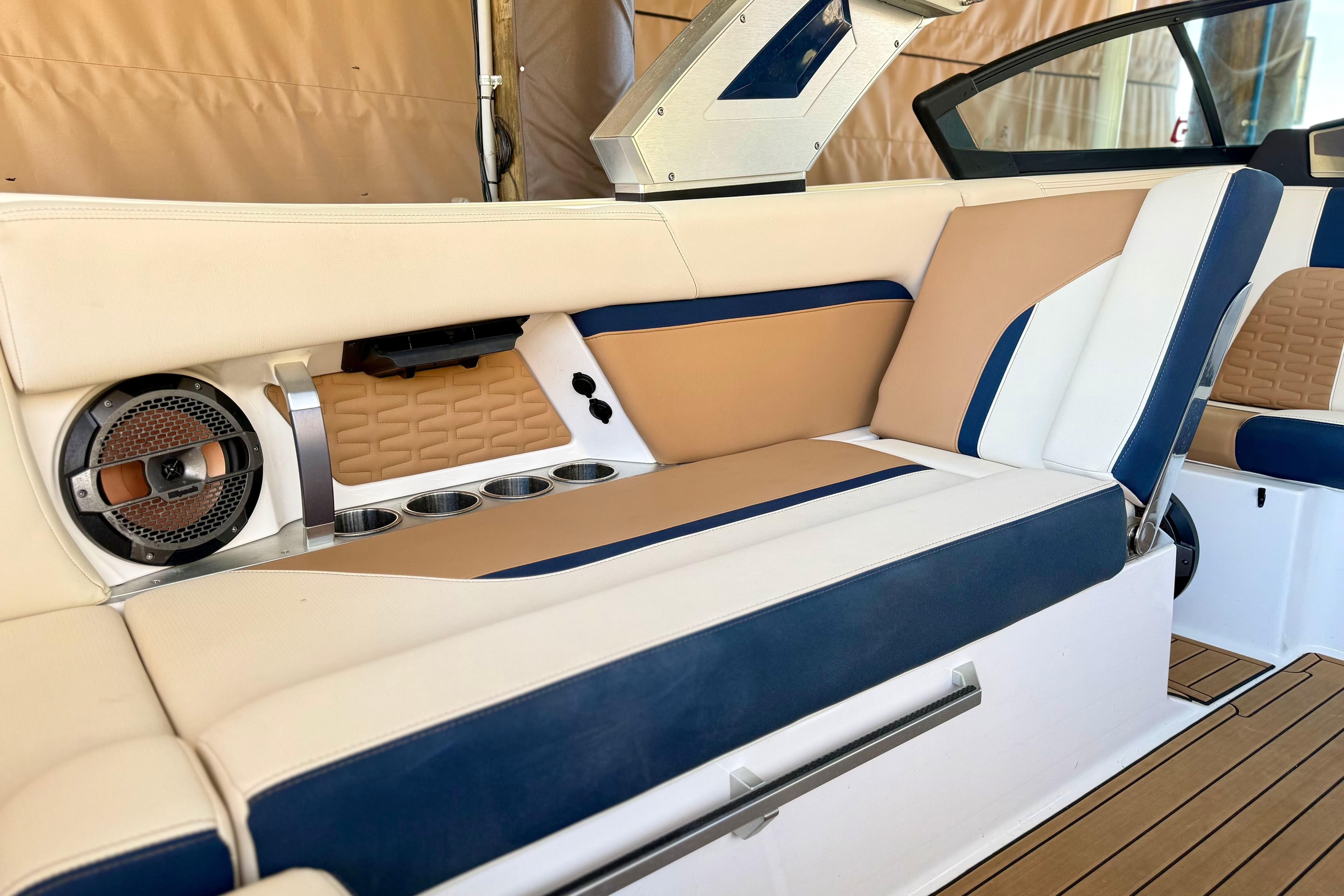 Luxurious interior of 2022 MasterCraft X24 boat with beige and blue seating.
