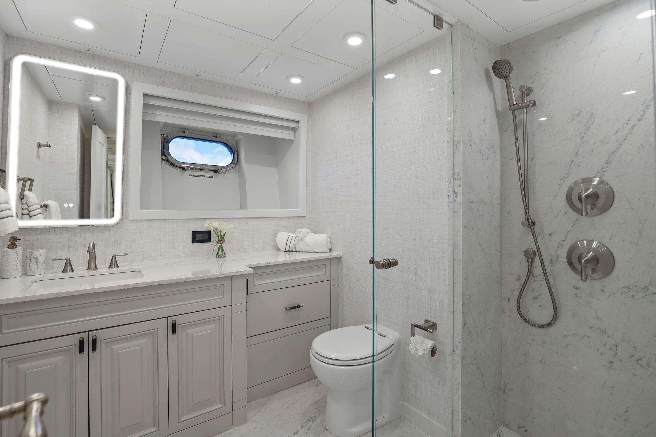 Luxurious yacht bathroom with marble shower, modern fixtures, and elegant vanity on Mengi Yay 115 MY.