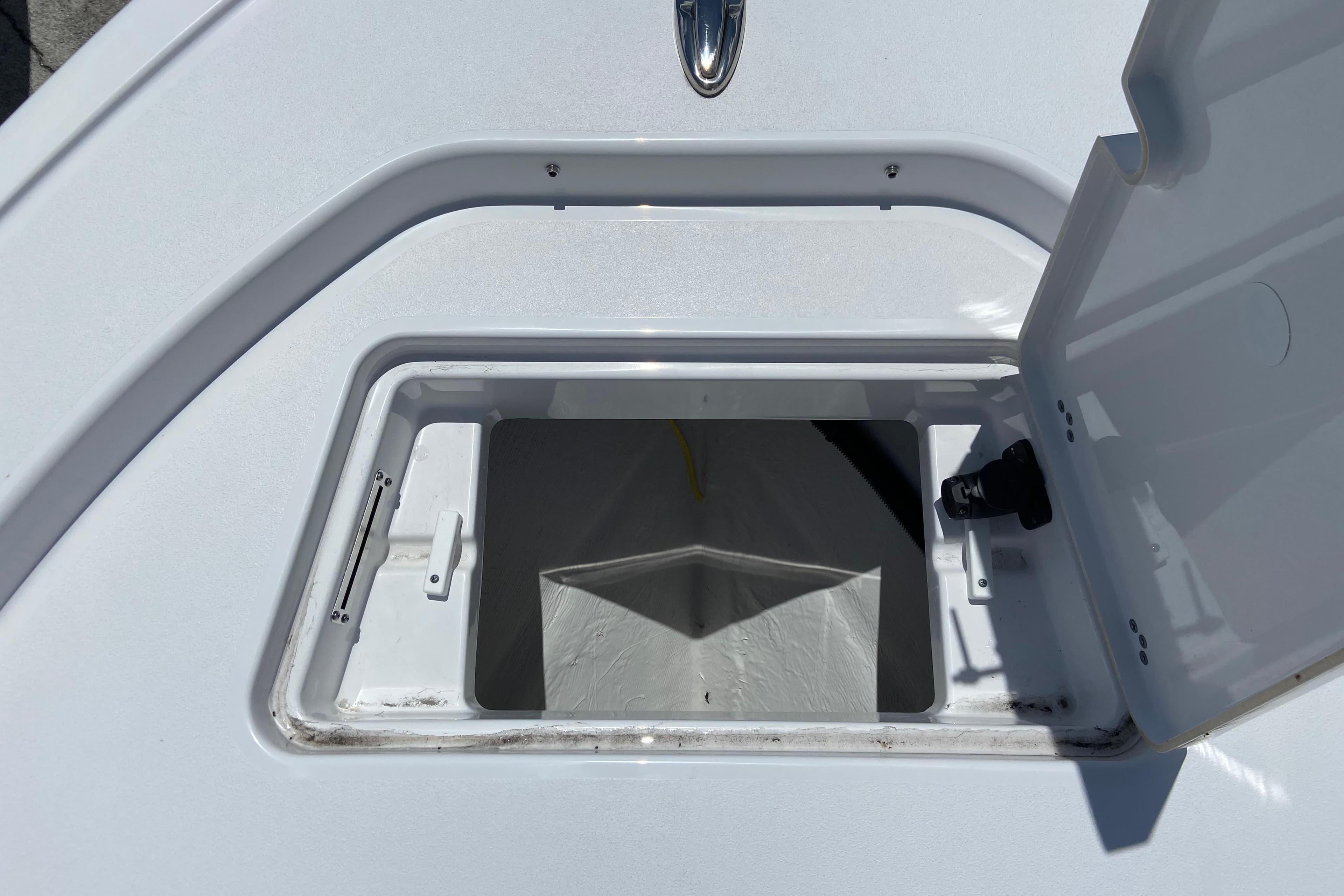 Open storage compartment on 2026 Sportsman Masters 227 Bay Boat deck.