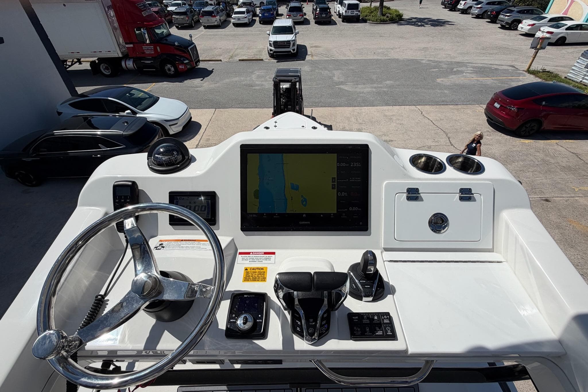 2024 Everglades 335 Center Console boat dashboard with steering wheel and navigation display.